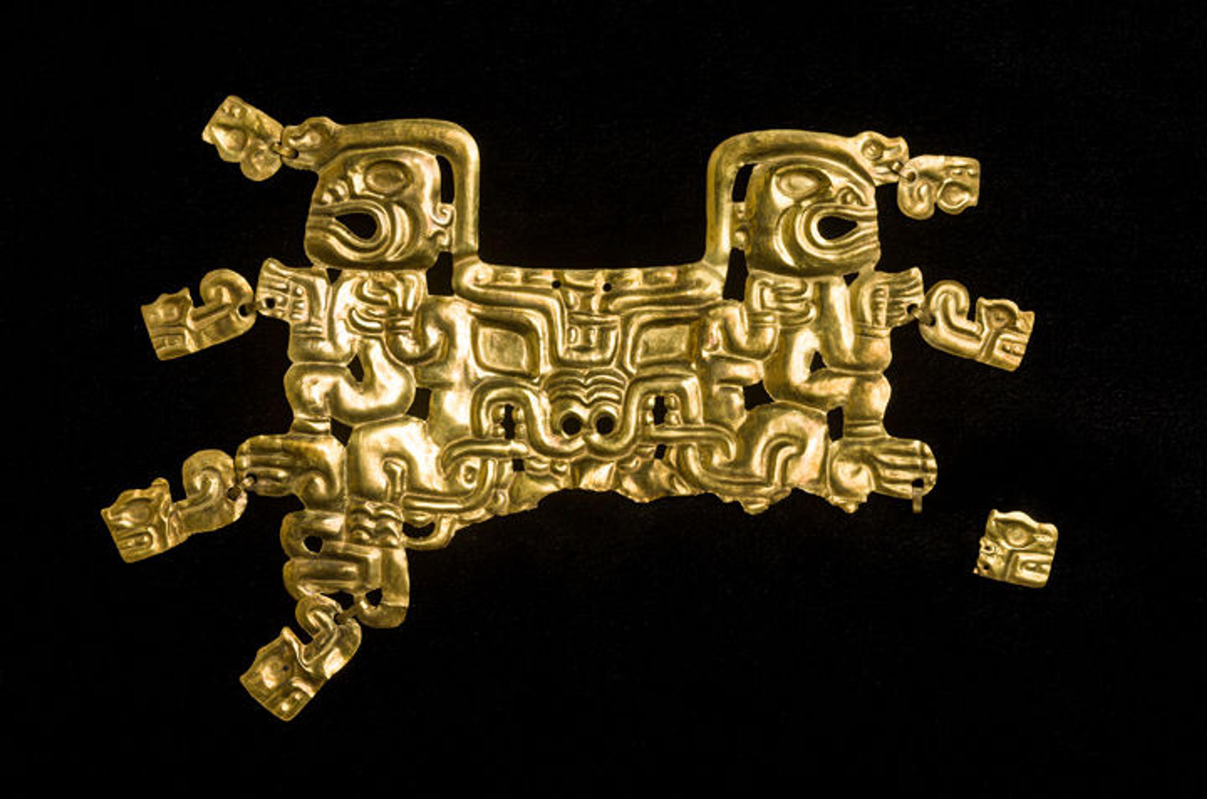 A gold mouth mask depicting a feline creature and human figures, made by the Cupisnique-Chavín peoples sometime between 800 and 550 B.C. 