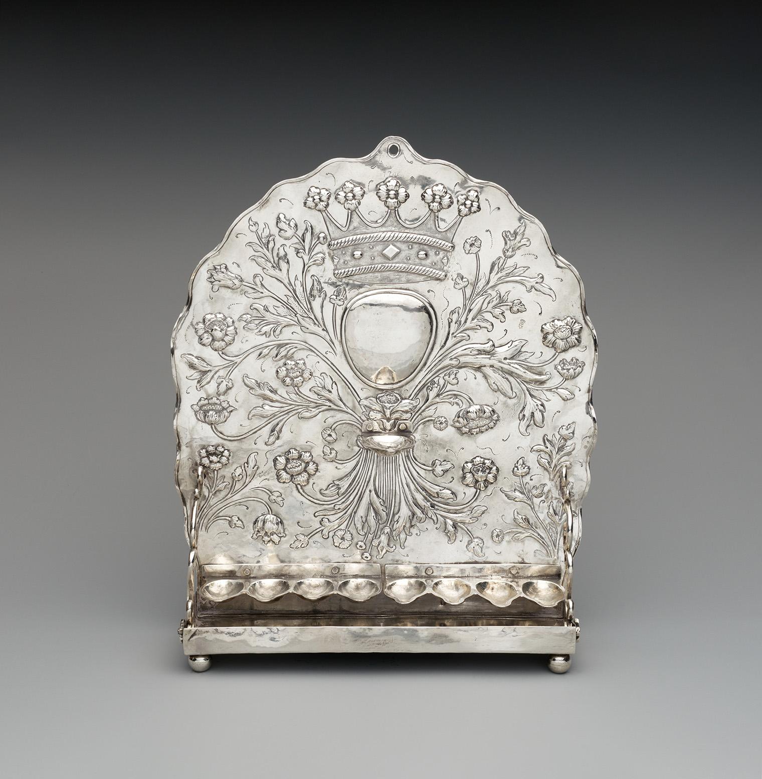 Ornate silver candle snuffer tray with intricate floral engravings and a crown emblem