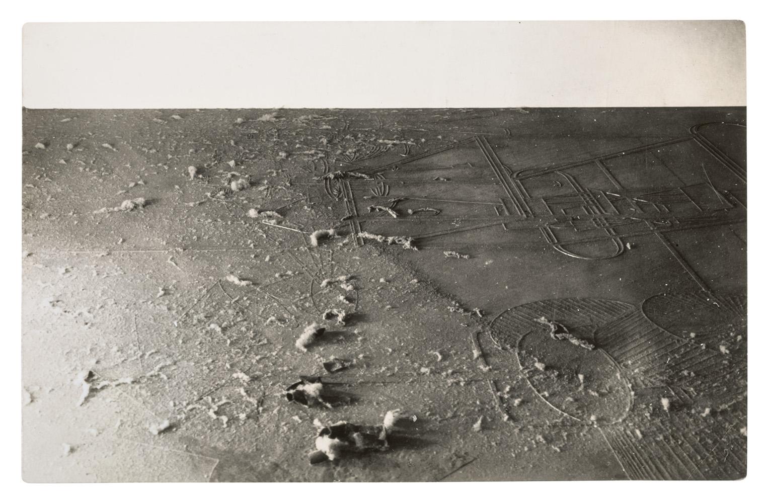 Dusty floor with intricate geometric patterns partially covered by a thin layer of dust. Soft footprints disrupt the dust, adding texture and intrigue.