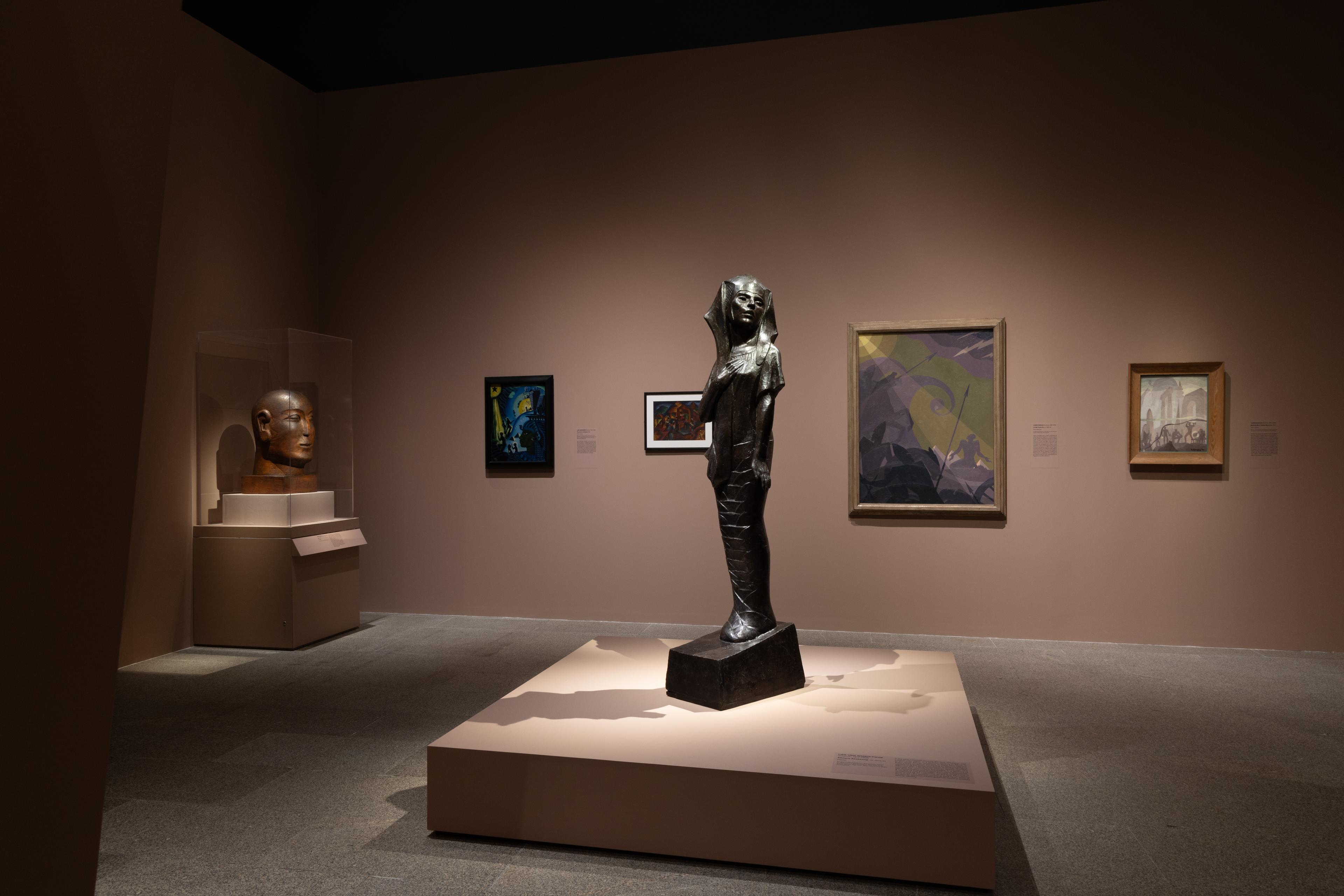 Gallery view of the Flight into Egypt with a female sculpture.