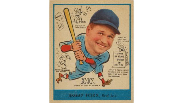 Vintage baseball card featuring a caricature of a smiling player in a blue uniform and cap, holding a bat. Cartoon figures and text praise his hitting.