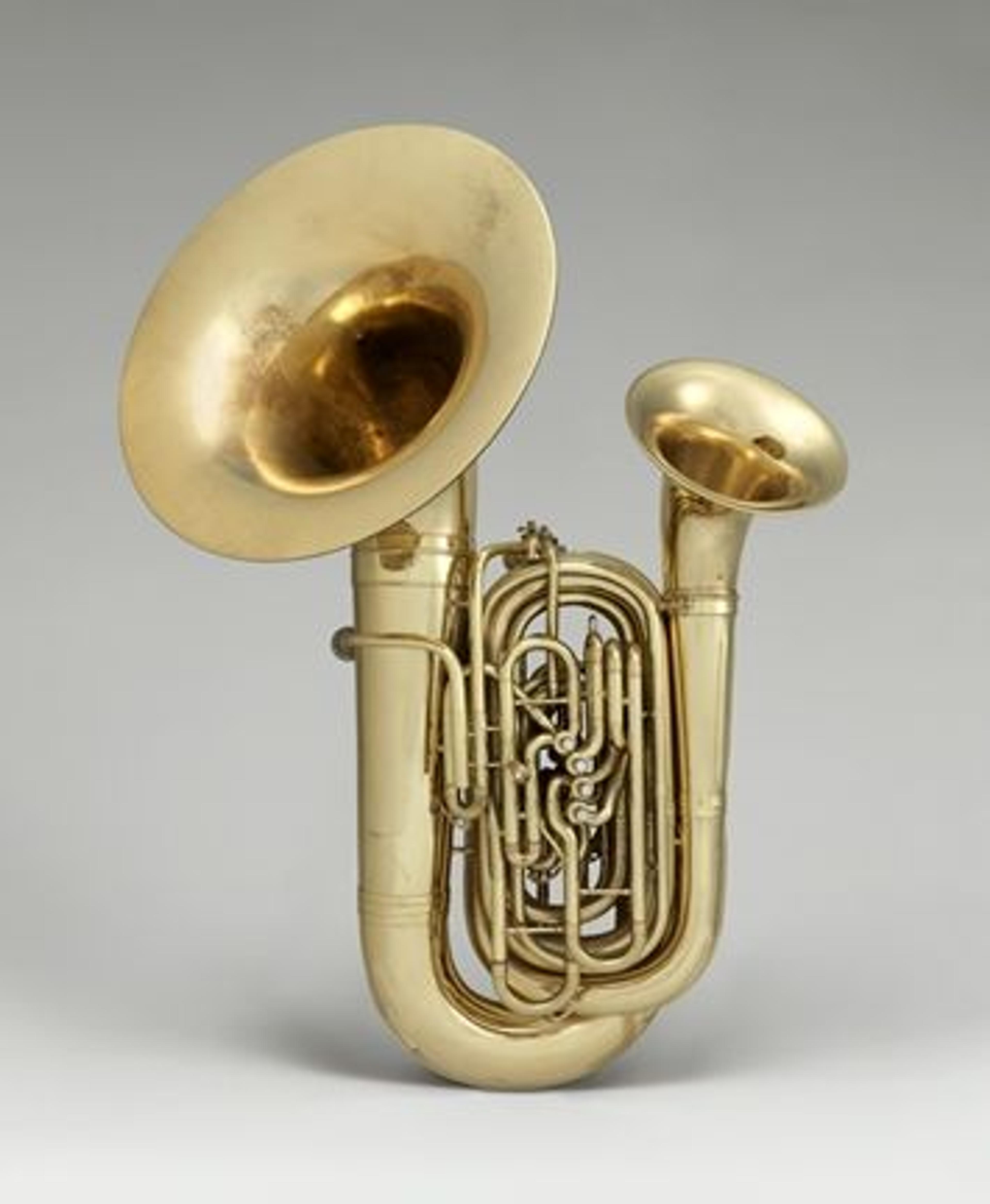 A brass instrument with two bells against a grey background