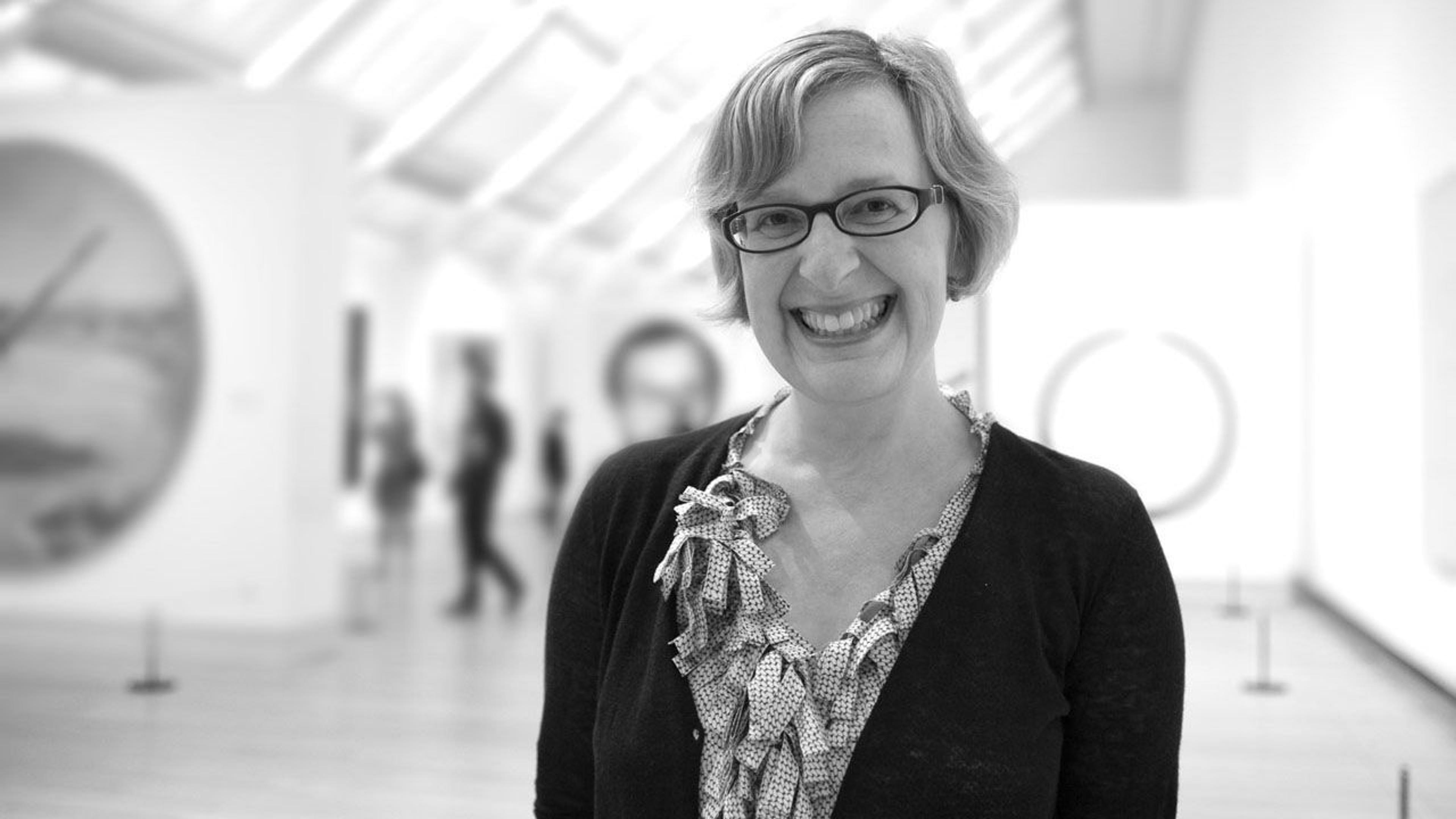 Black and white photograph of art historian Kathy Galitz standing in a gallery at The Met