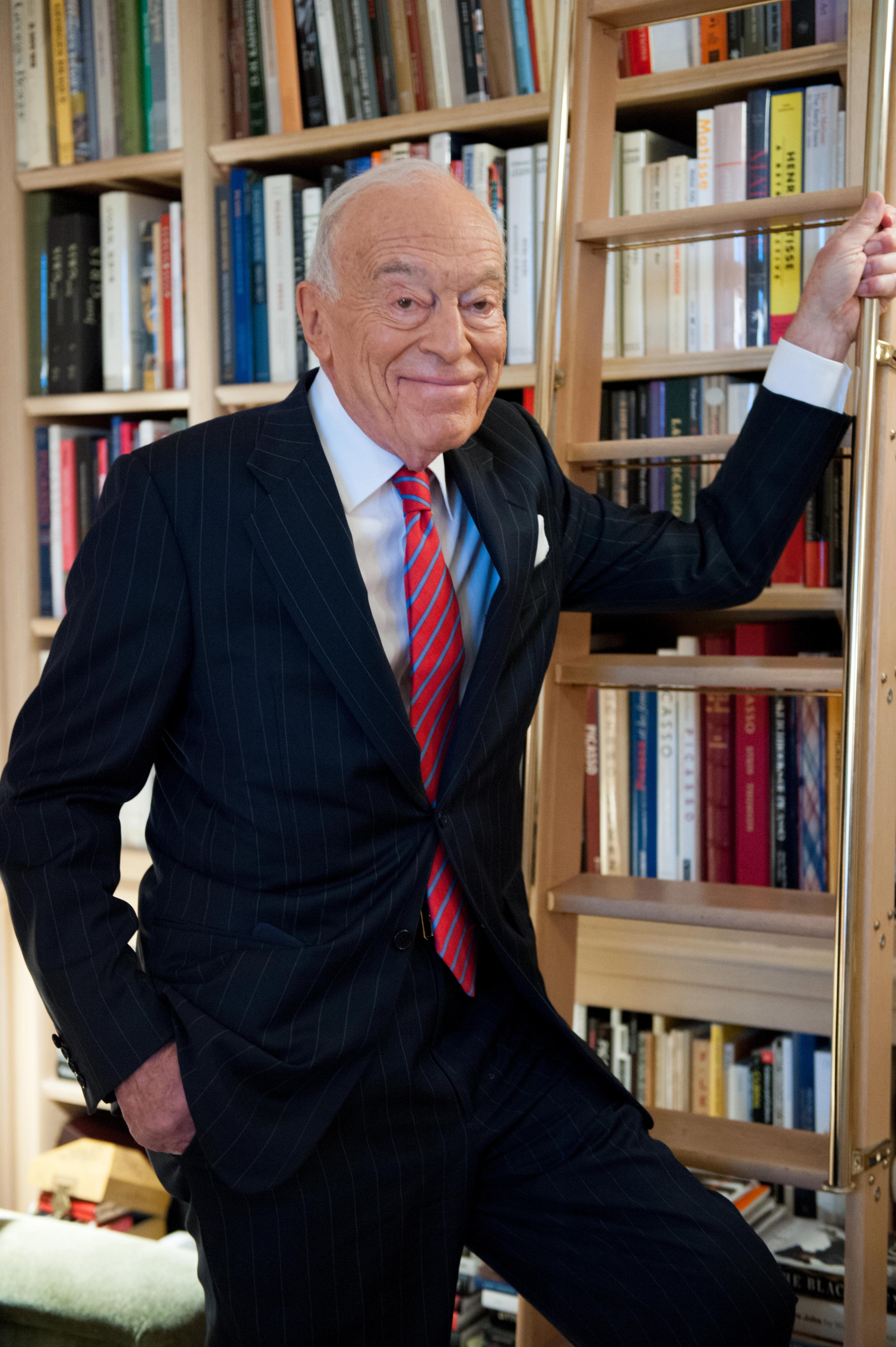 Lauder posing alongside a library ladder.