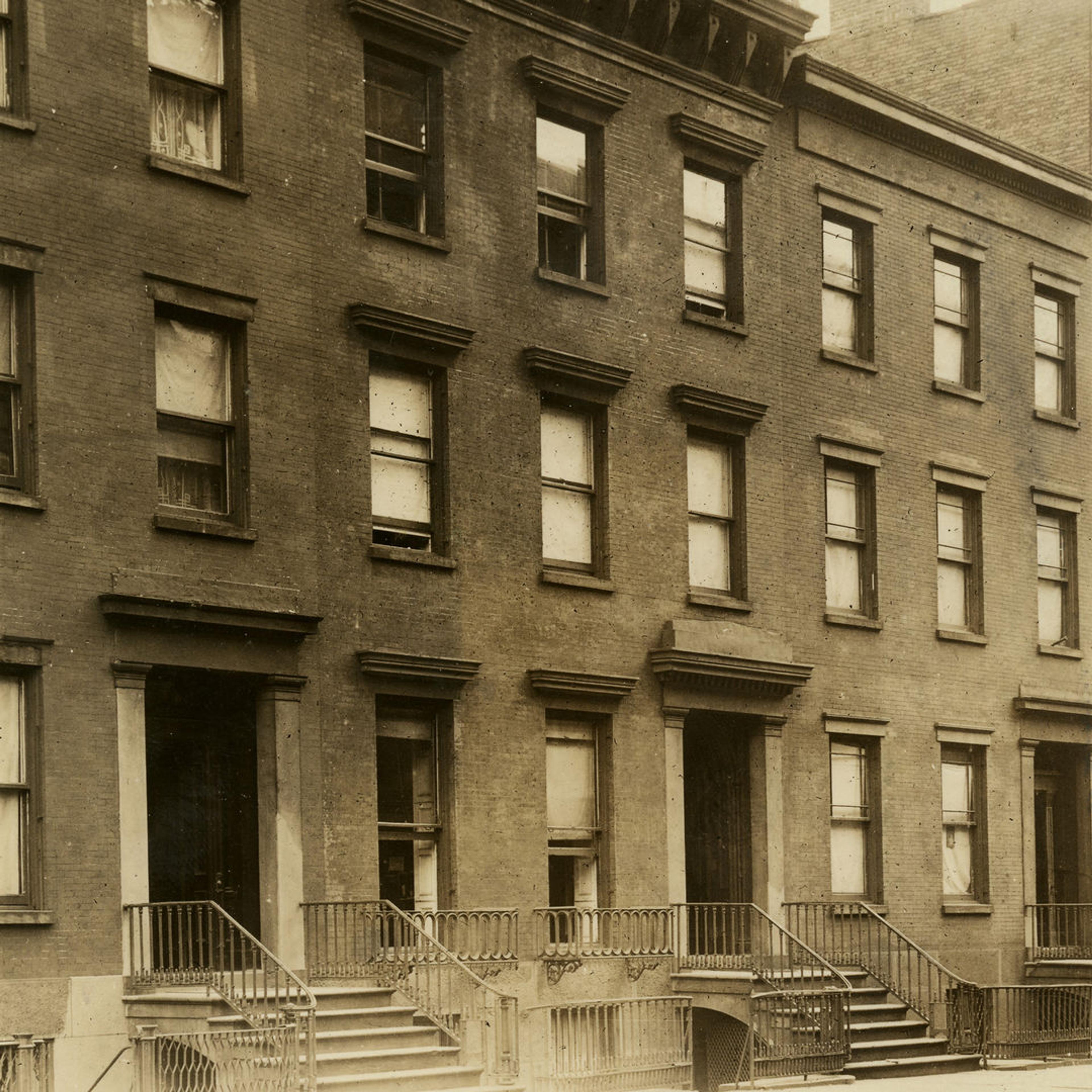 The buildings that field owned before they were torn down in a sepia photograph.
