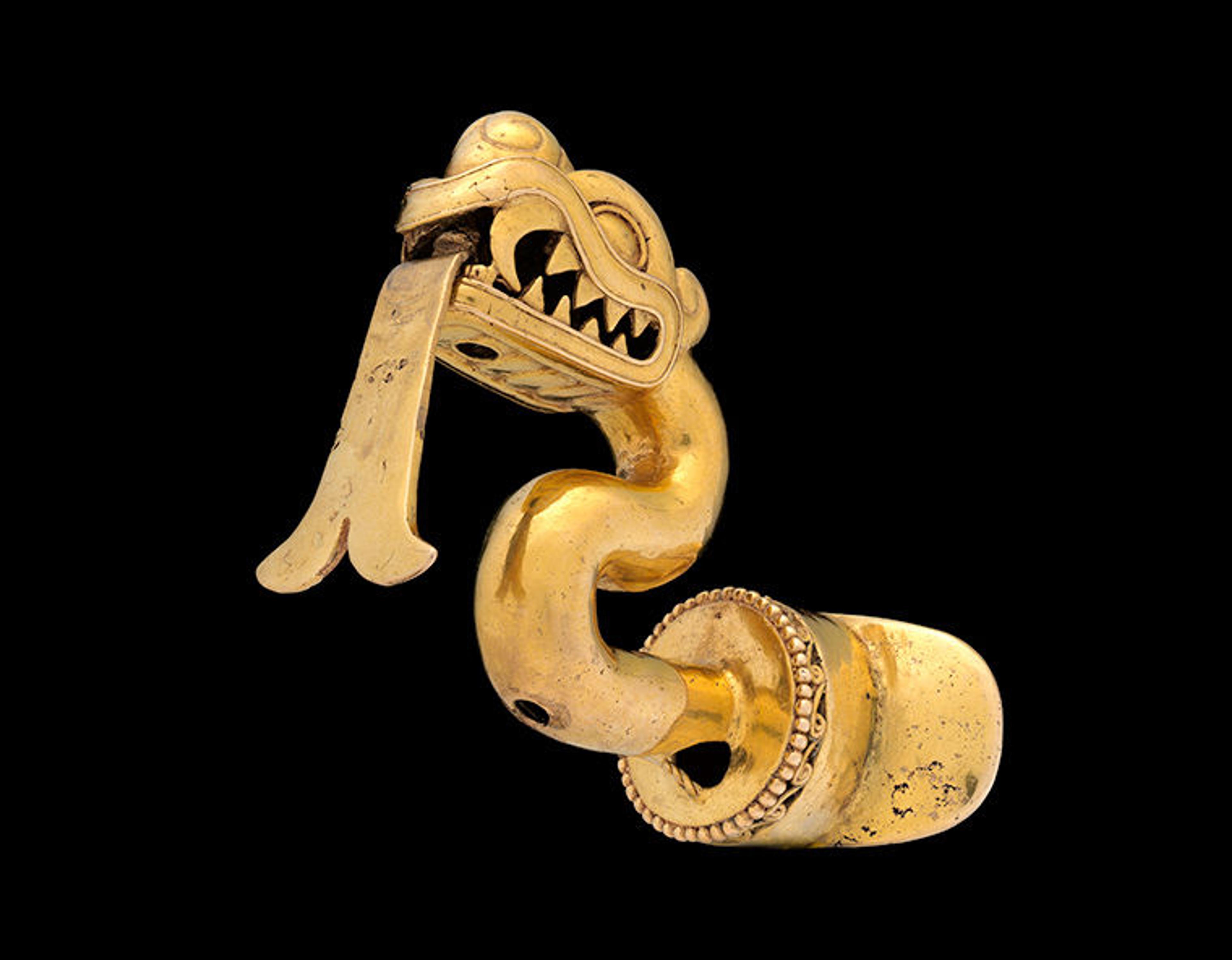 A lip ornament in the shape of a snake-like creature. 