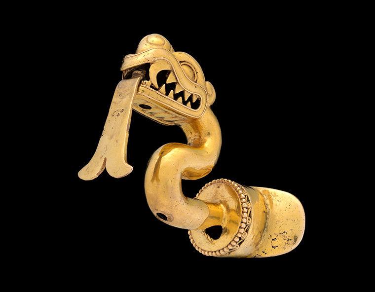 A lip ornament in the shape of a snake-like creature.