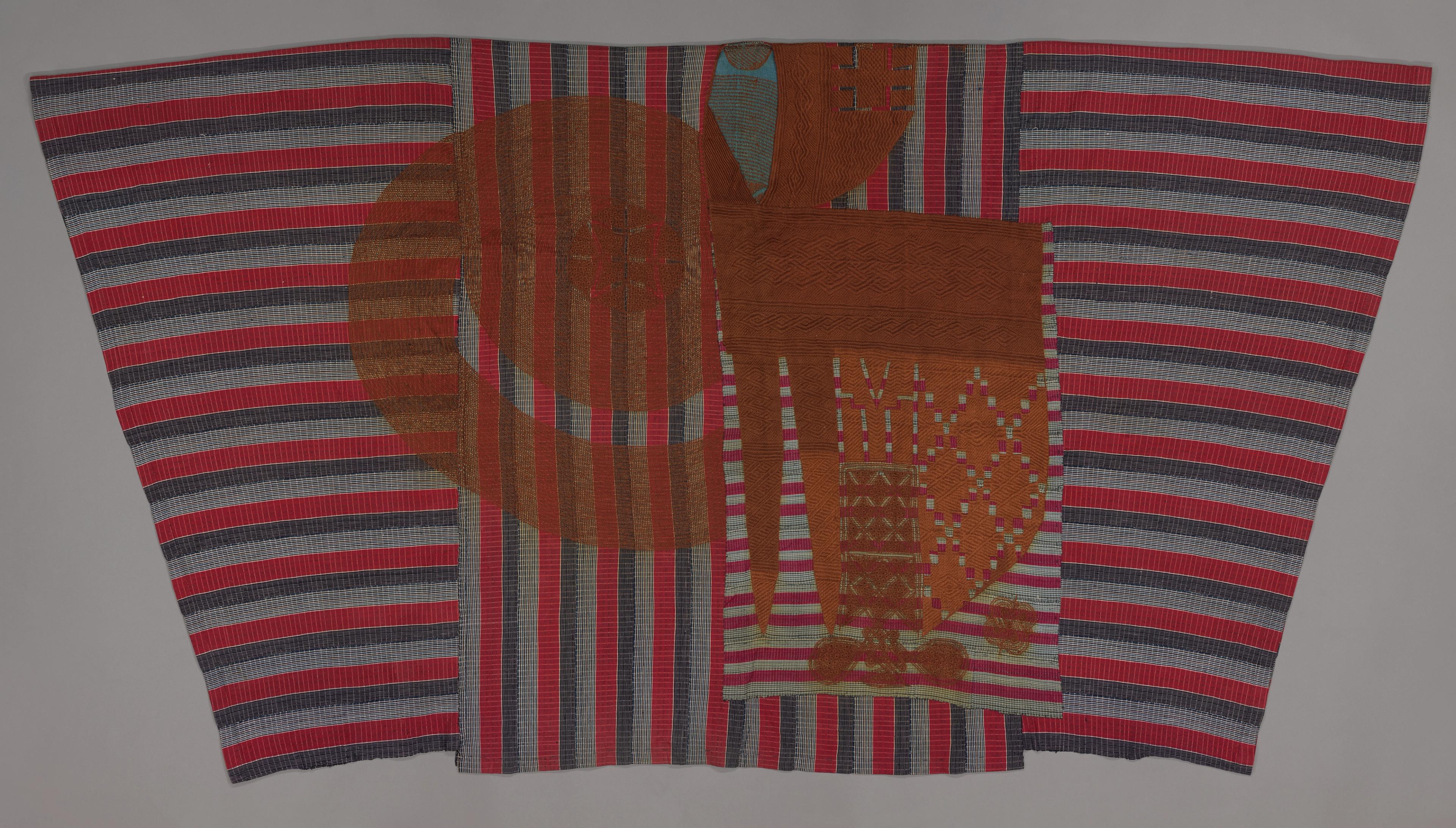 Striped robe in red, blue, and white with a central panel featuring abstract shapes and patterns.