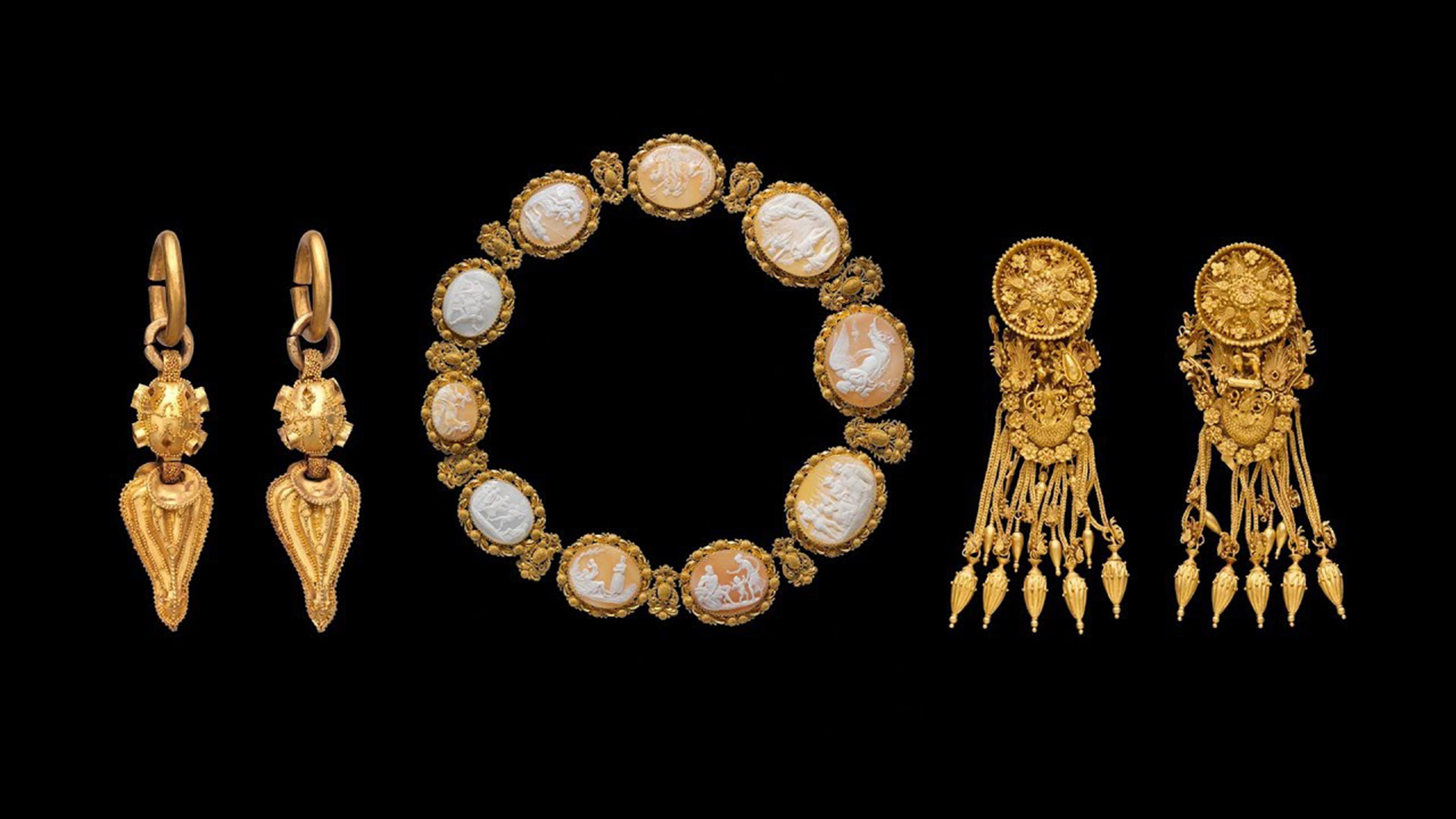 Ornate pairs of gold earrings and a bracelet.