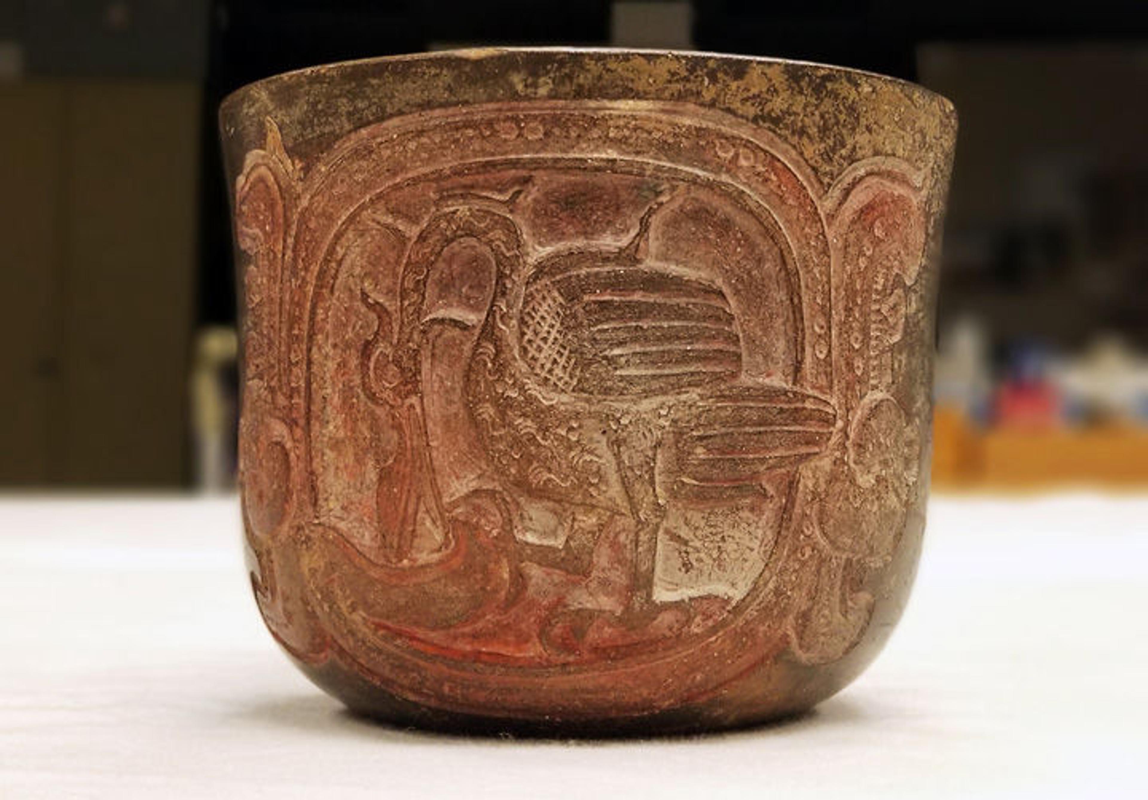 A Mexican drinking vessel featuring a depiction of a water bird and hieroglyphic text