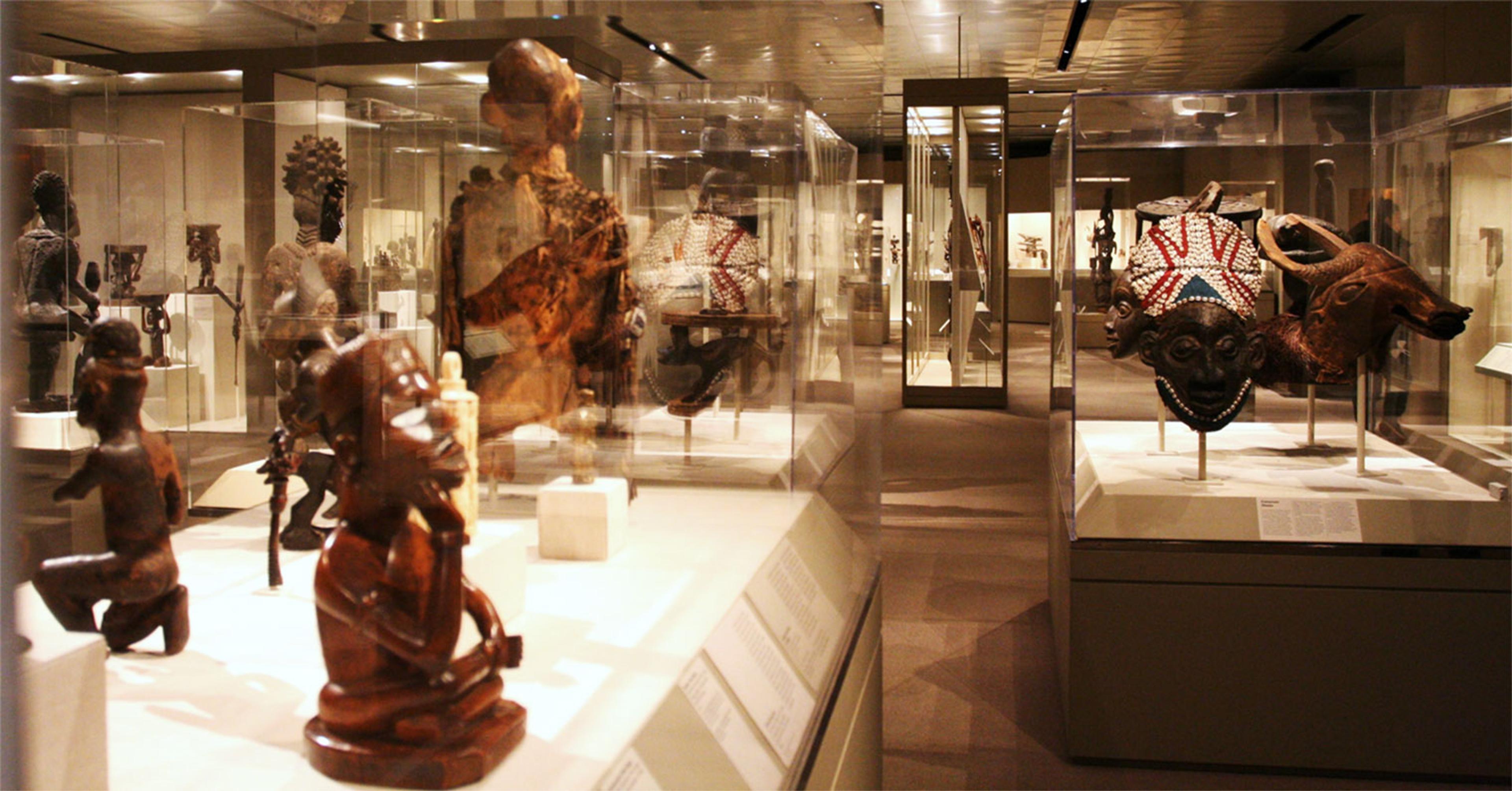 View of African art gallery showing objects in glass display cases