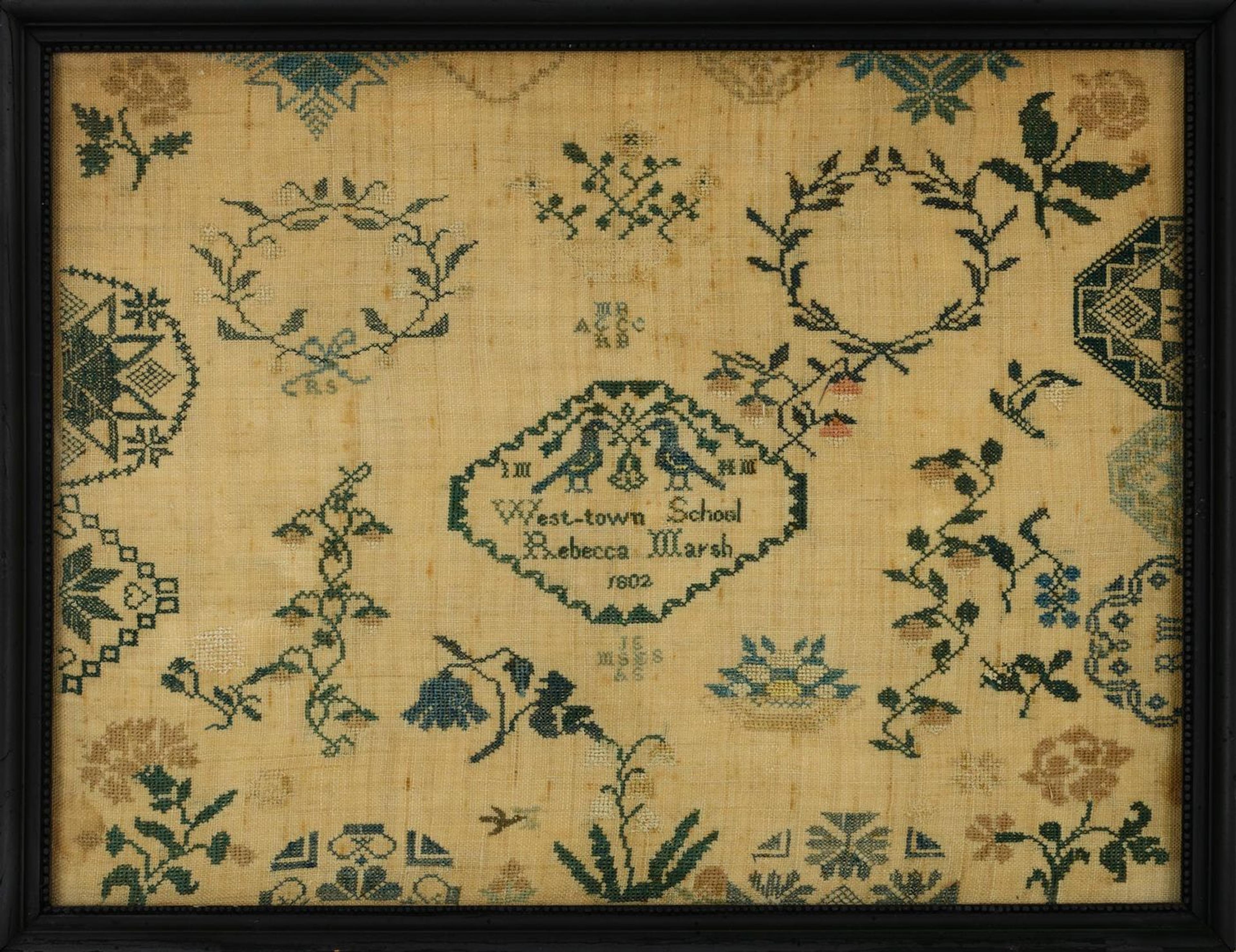 An image of a sampler by Rebecca Marsh. A design of yellow, blue, and pink flowers and rings of green leaves features Rebecca's name and school in the center.