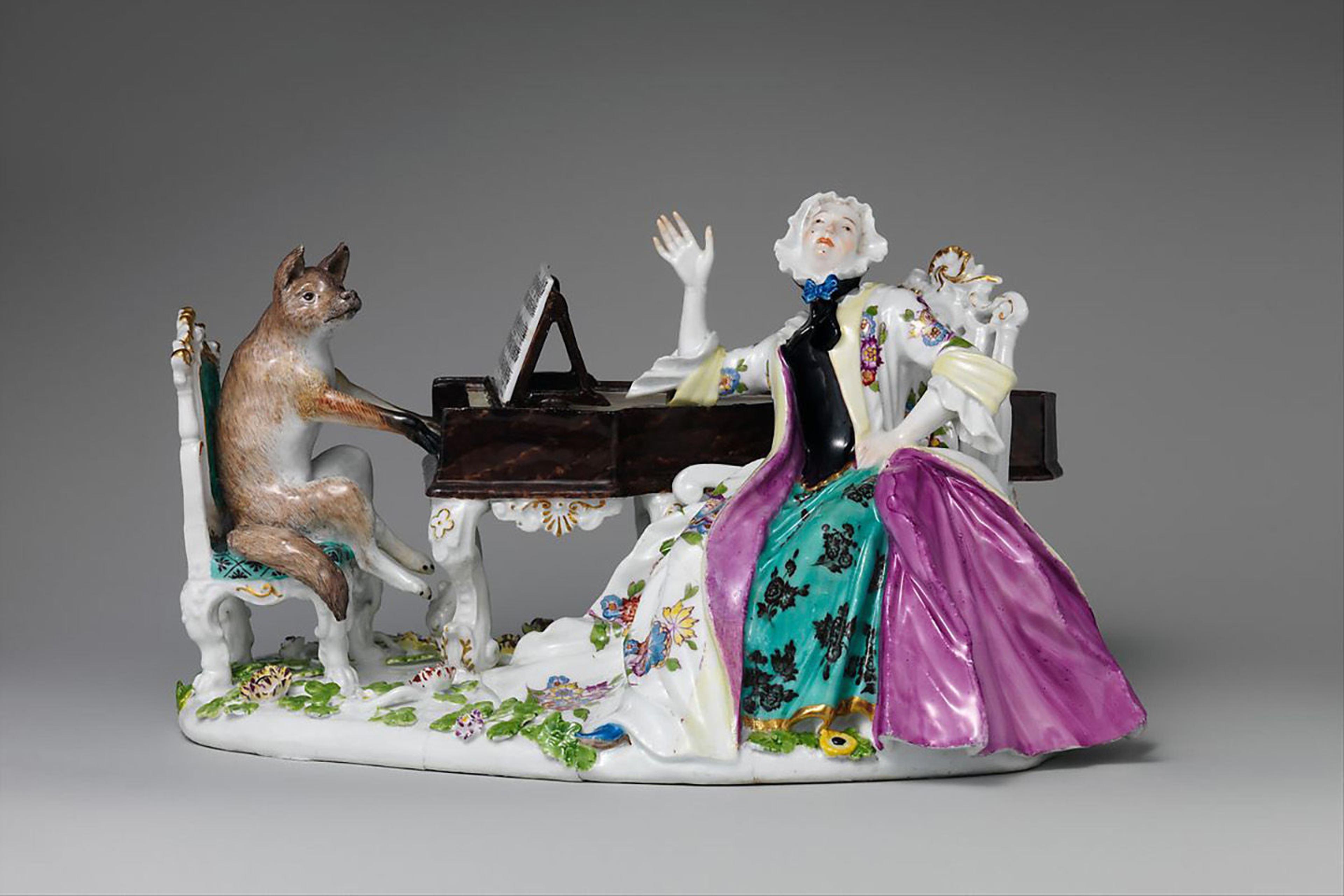 Porcelain figurine from the Meissen Manufactory of a singler, Faustina Bordoni, and a fox playing the piano
