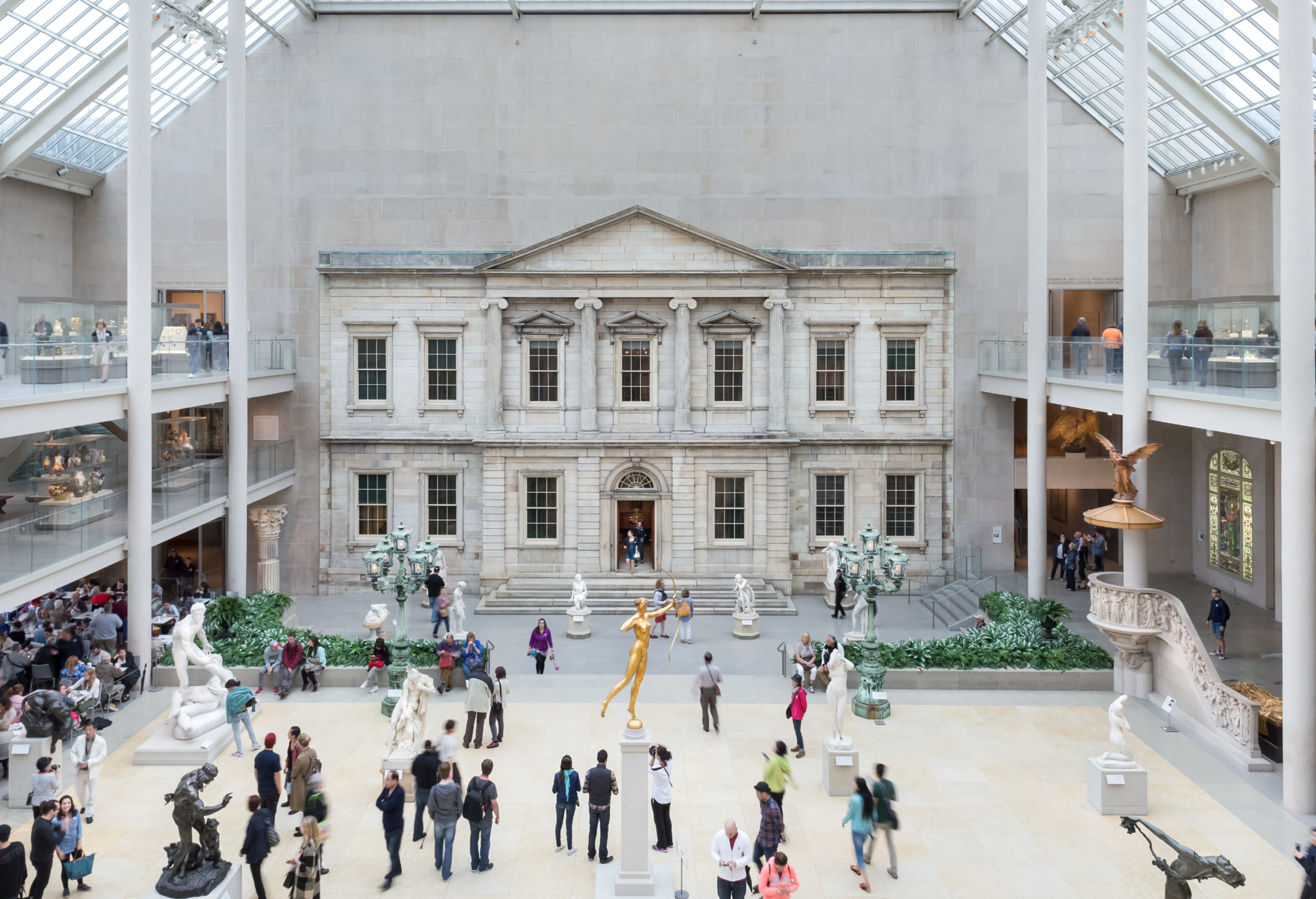 A sweeping shot of The Met's Charles Englehard Court-an airy room dotted with stone and metal sculptures and highlighted by a 19th-century bank facade.
