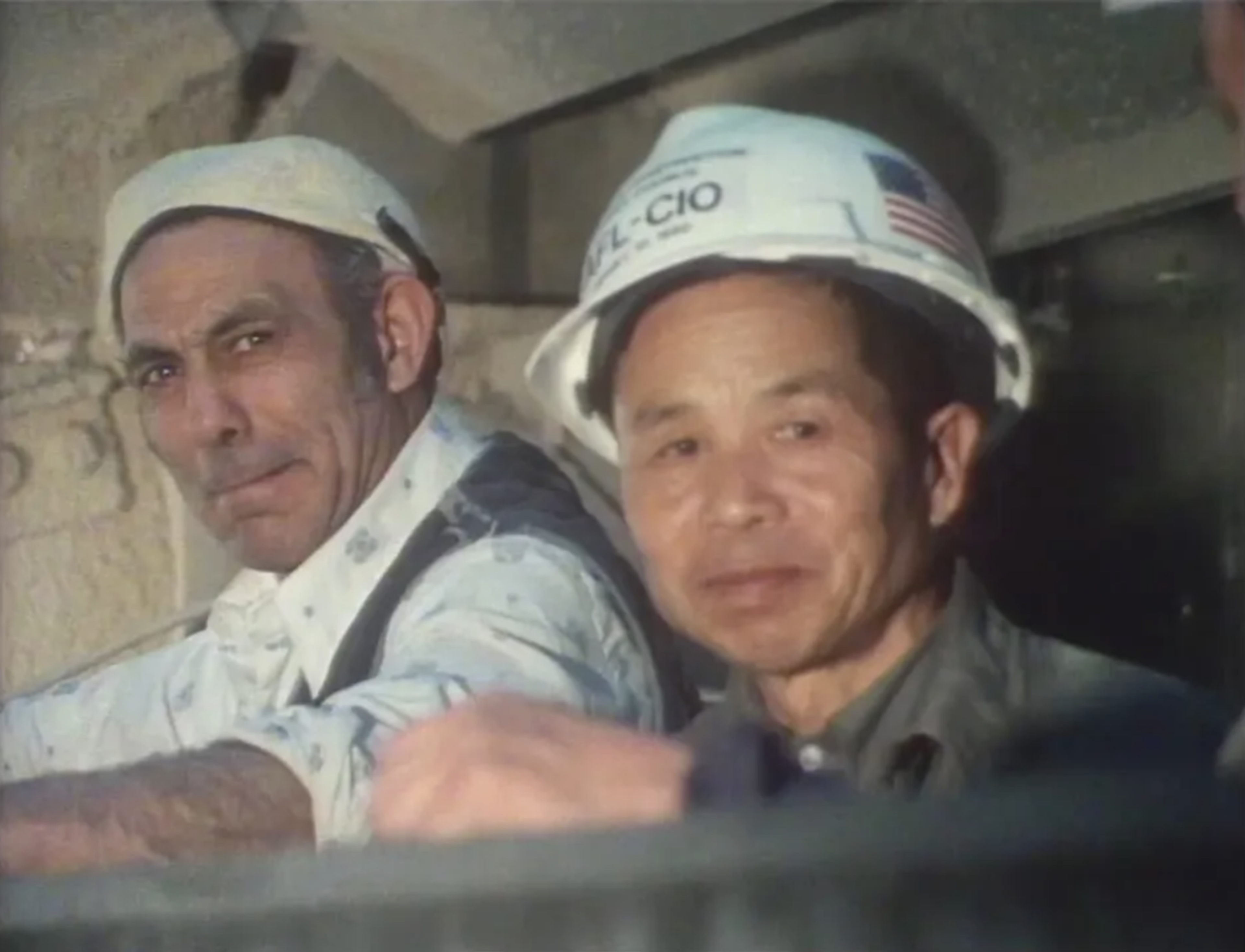 Two construction workers onsite installing the Ming Garden in Astor Court.
