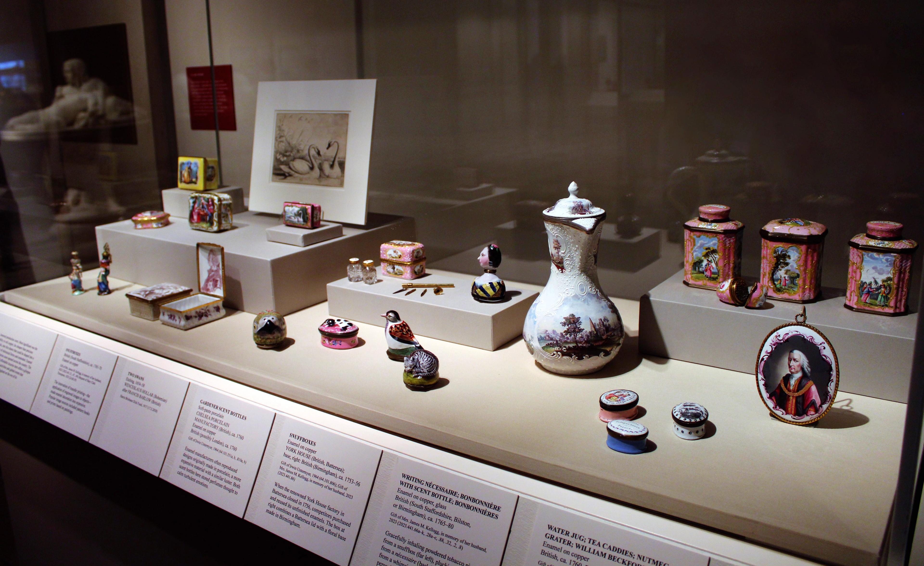 Glass vitrine showcasing numerous, brightly colored porcelain objects.