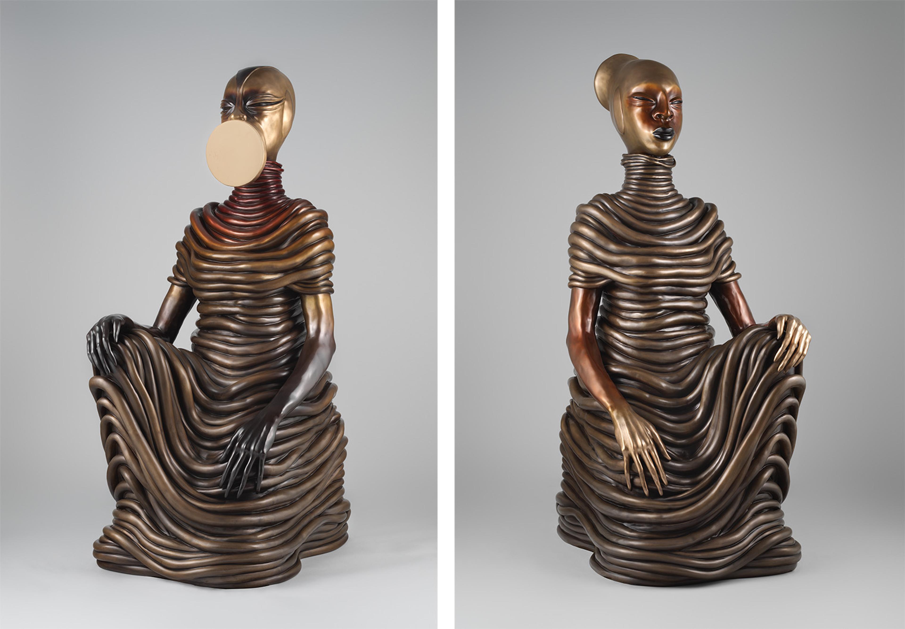 Side-by-side of two sculptures of seated figures with ribbed, undulating garments. Left: face obscured by disk, right: serene expression.