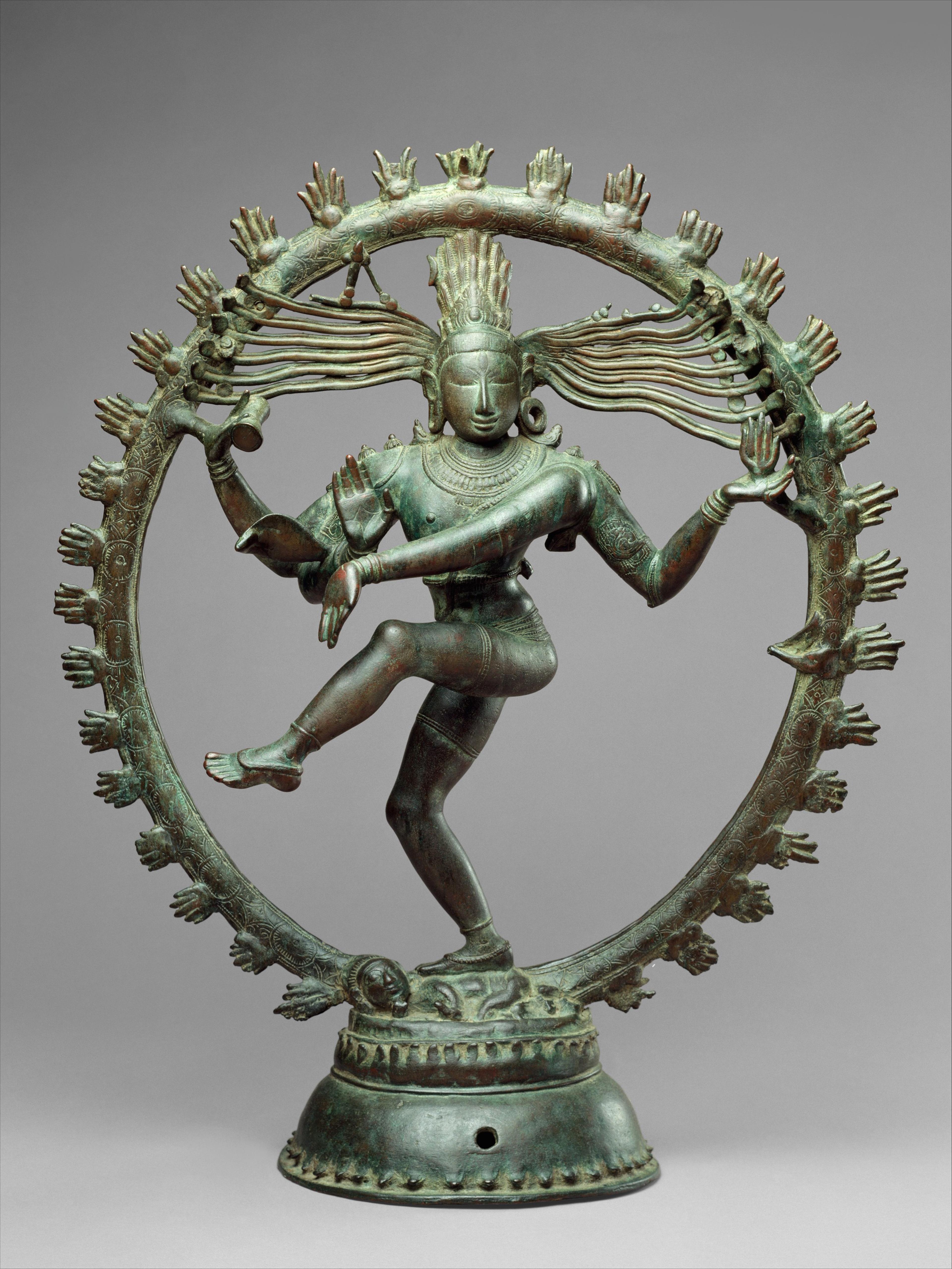 Bronze sculpture of Shiva as Lord of Dance, dancing within a ring of flames, one leg raised and multiple arms extended in dynamic motion.