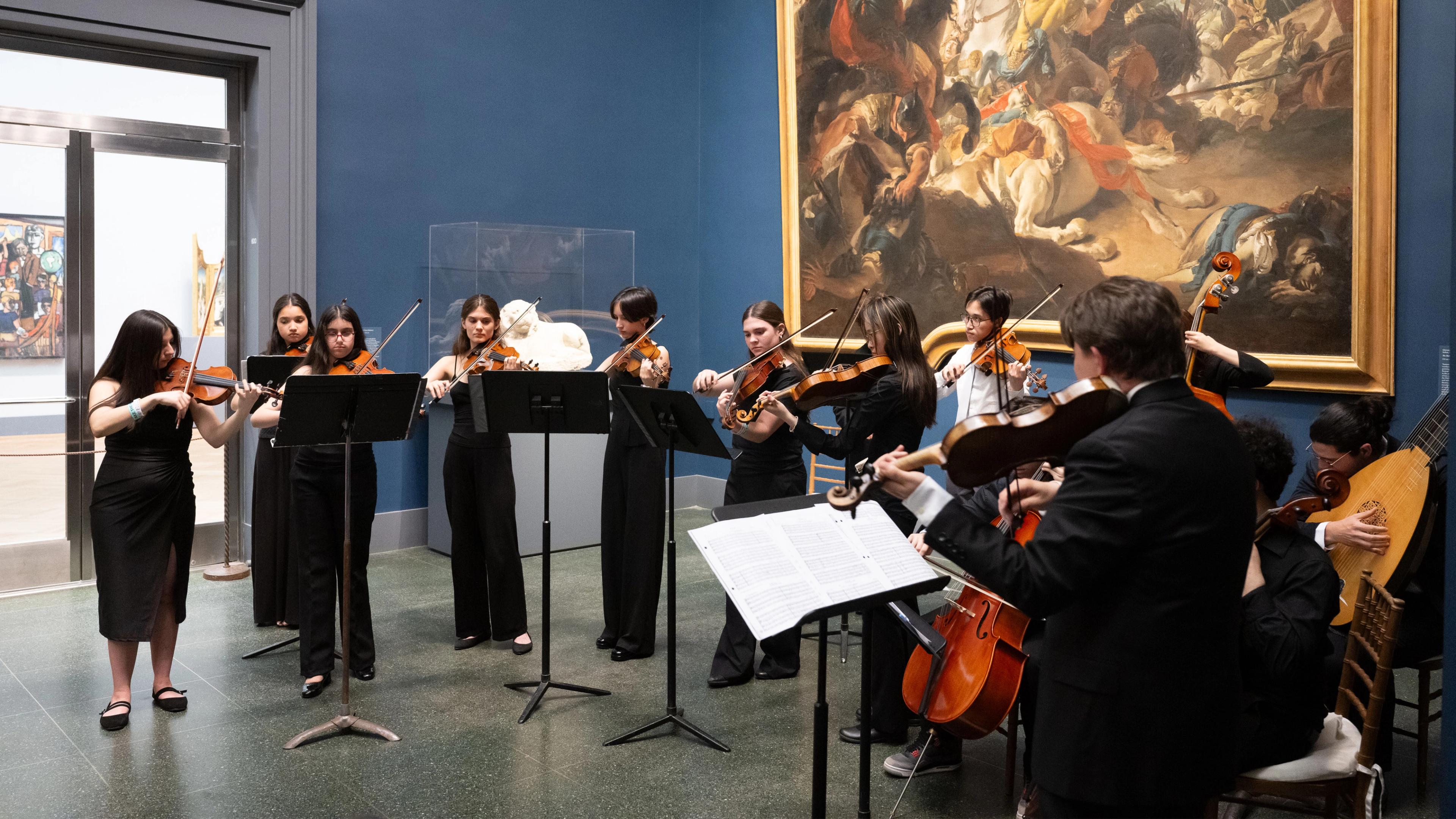 A group of musicians performing together at The Met