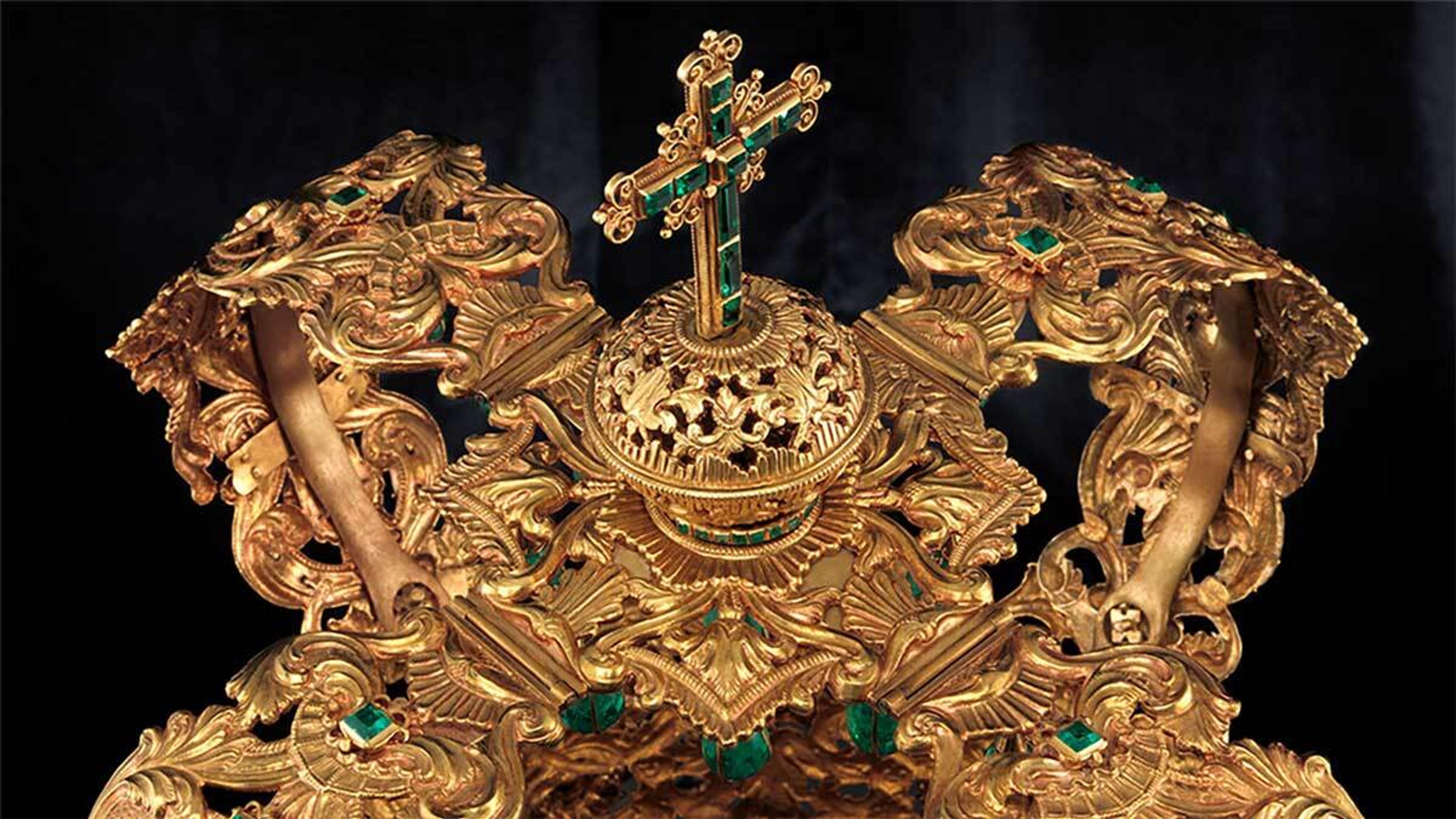 An ornate gold and emerald crown