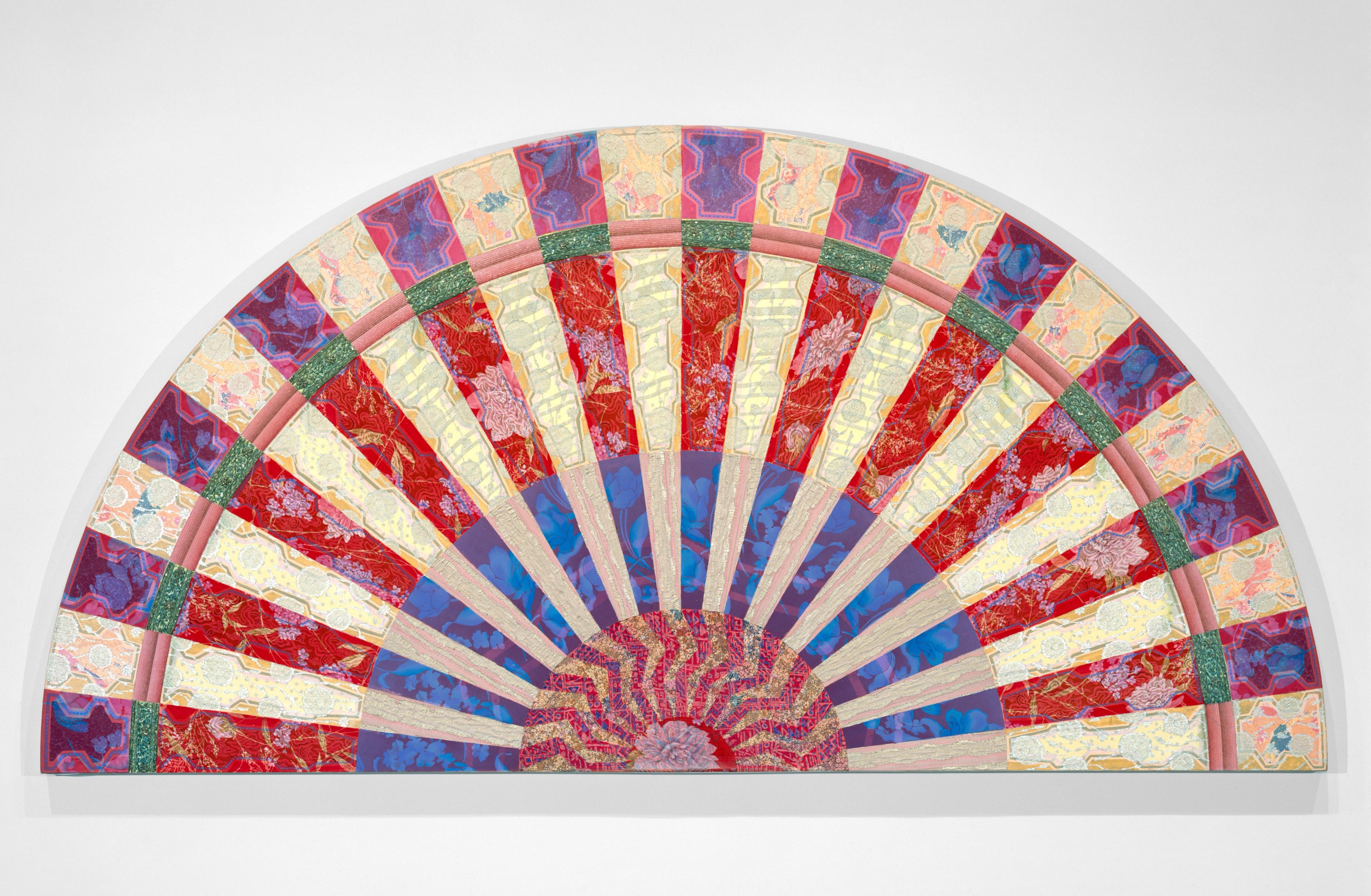 Semi-circular quilt art with vibrant red, yellow, and blue geometric patterns.
