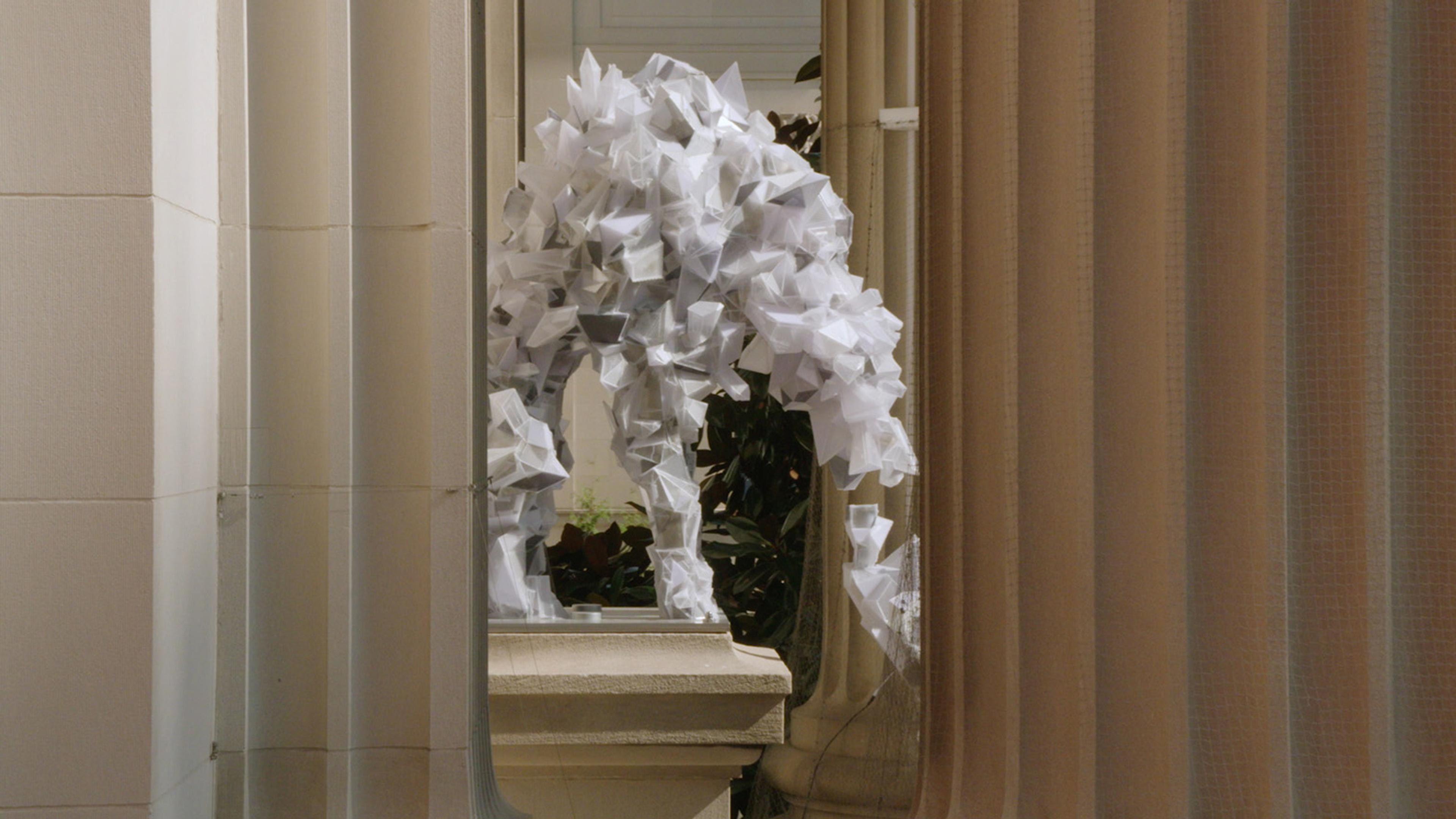 Sculptures made of various white shapped cubes, dipicting a dog.