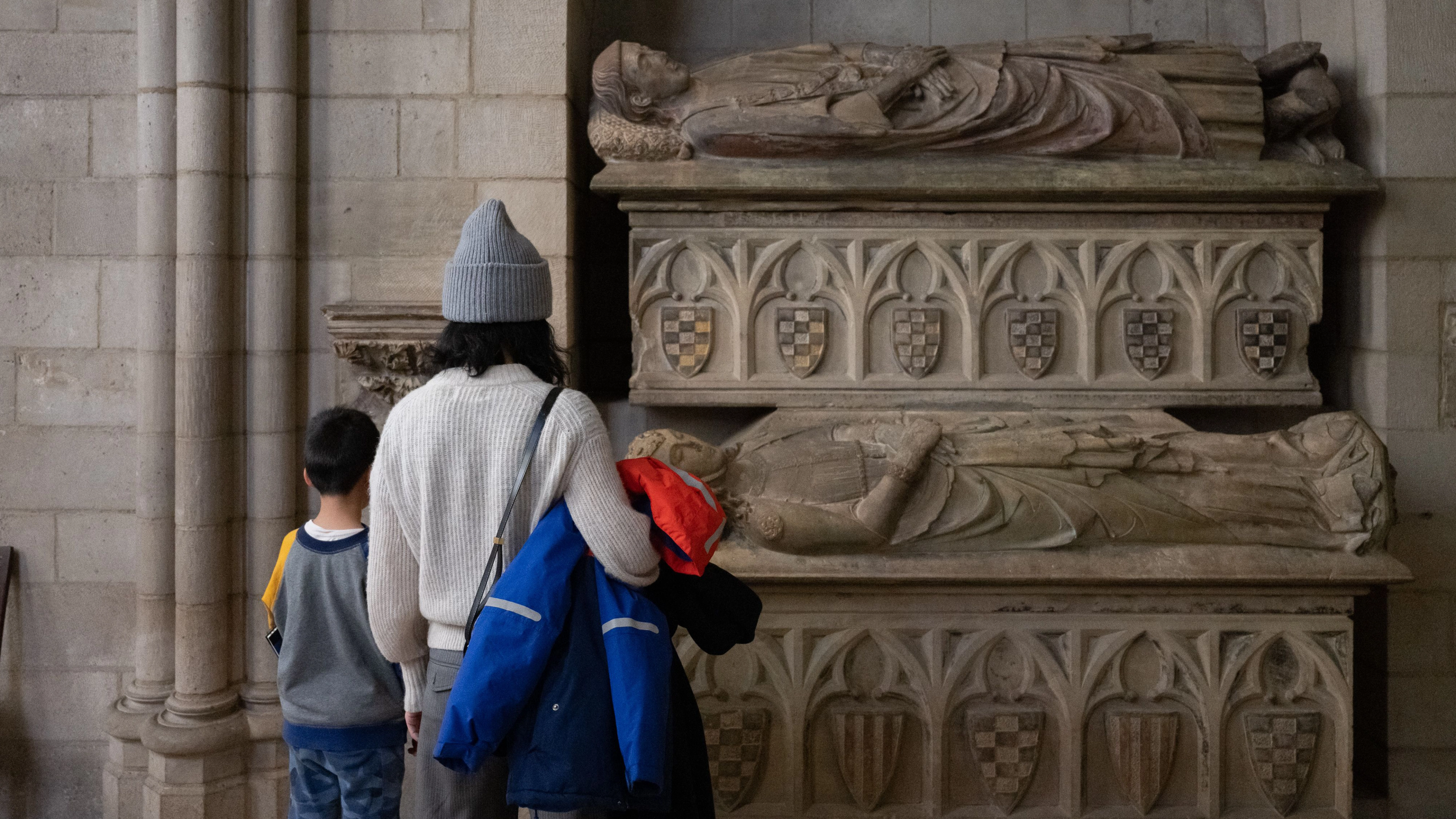 Two individuals look at objects on view at The Met Cloisters.