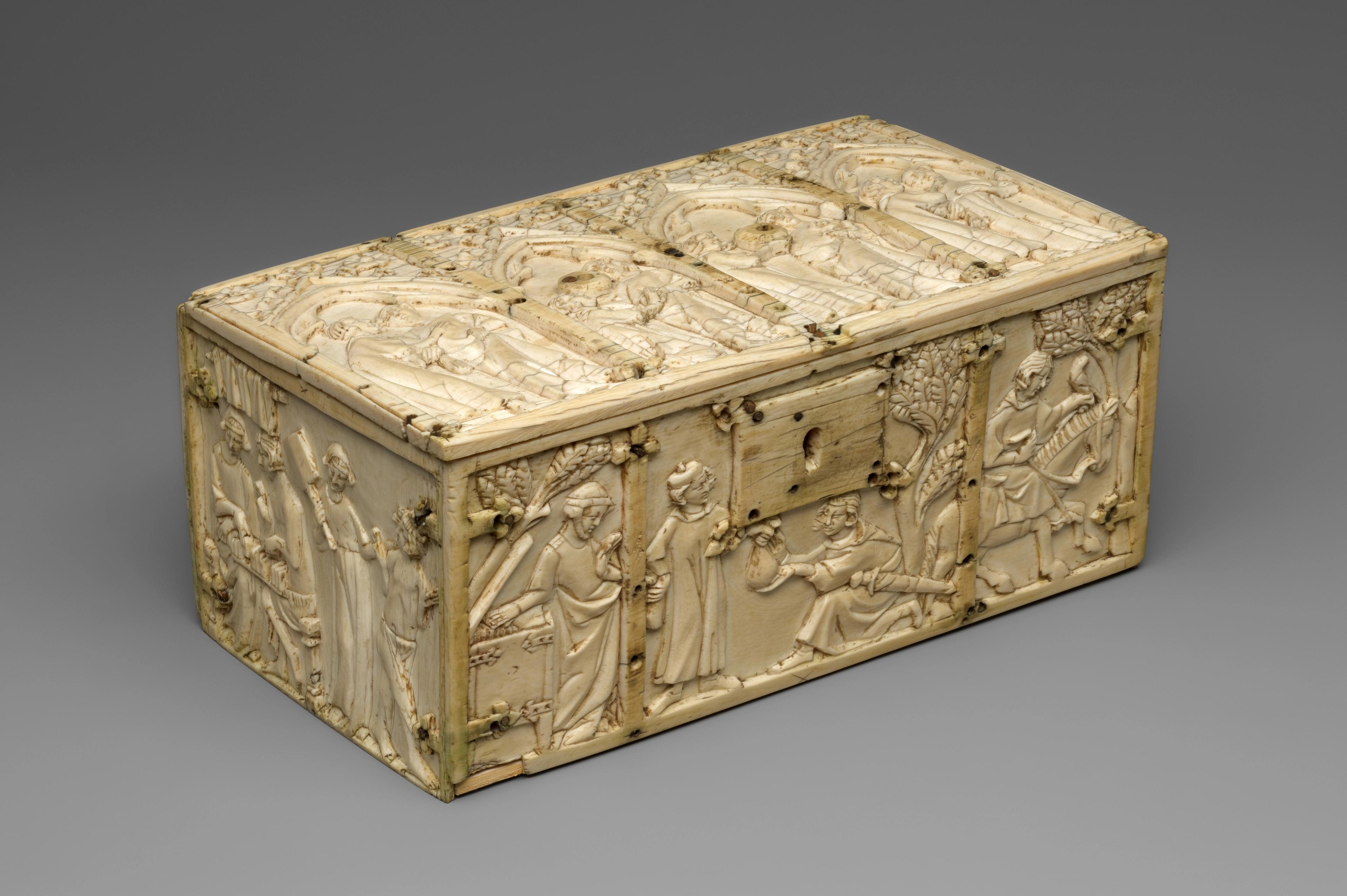 Ivory box with carved religious scenes on the lid and sides.