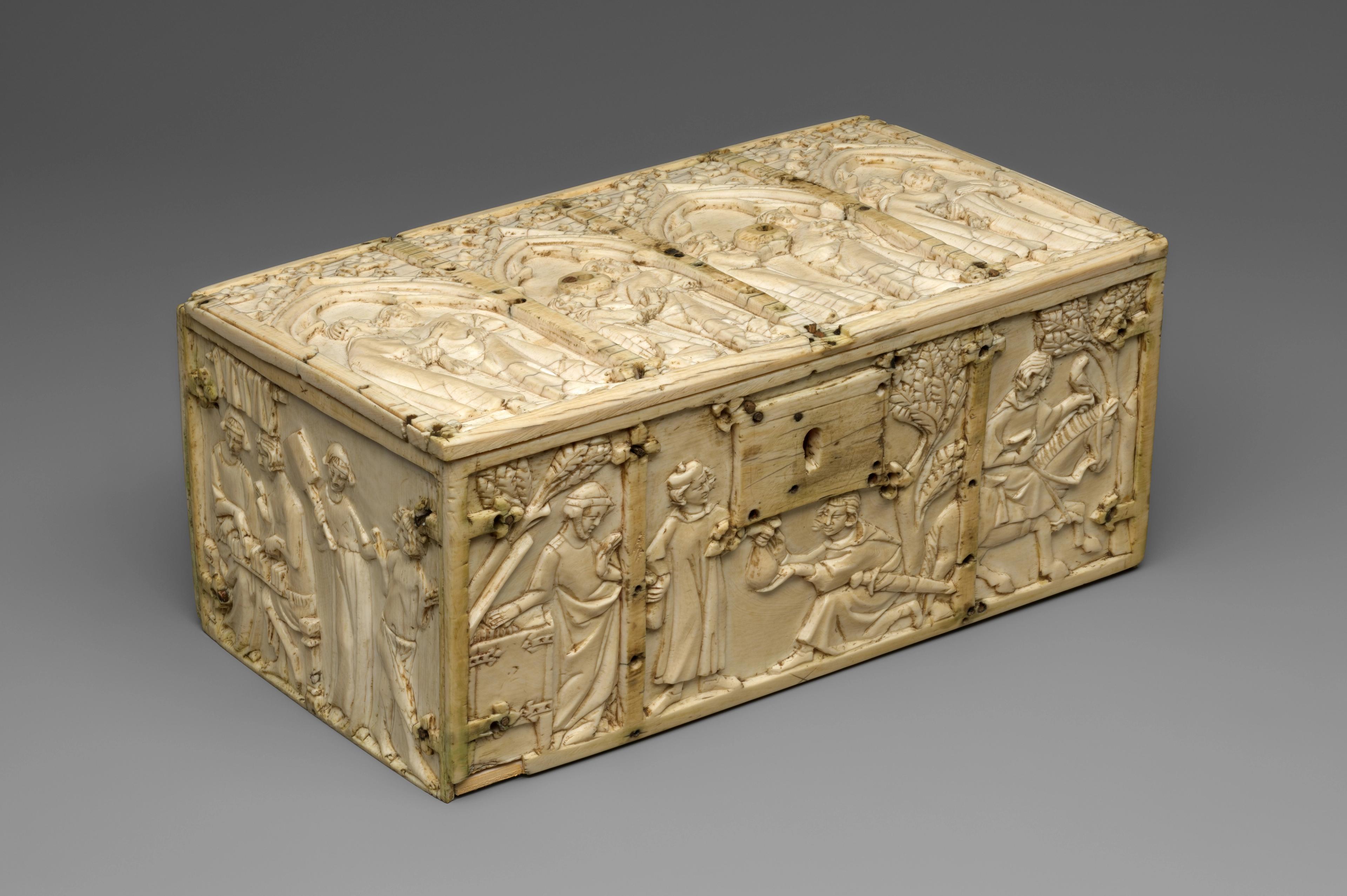 Ivory box with carved religious scenes on the lid and sides.