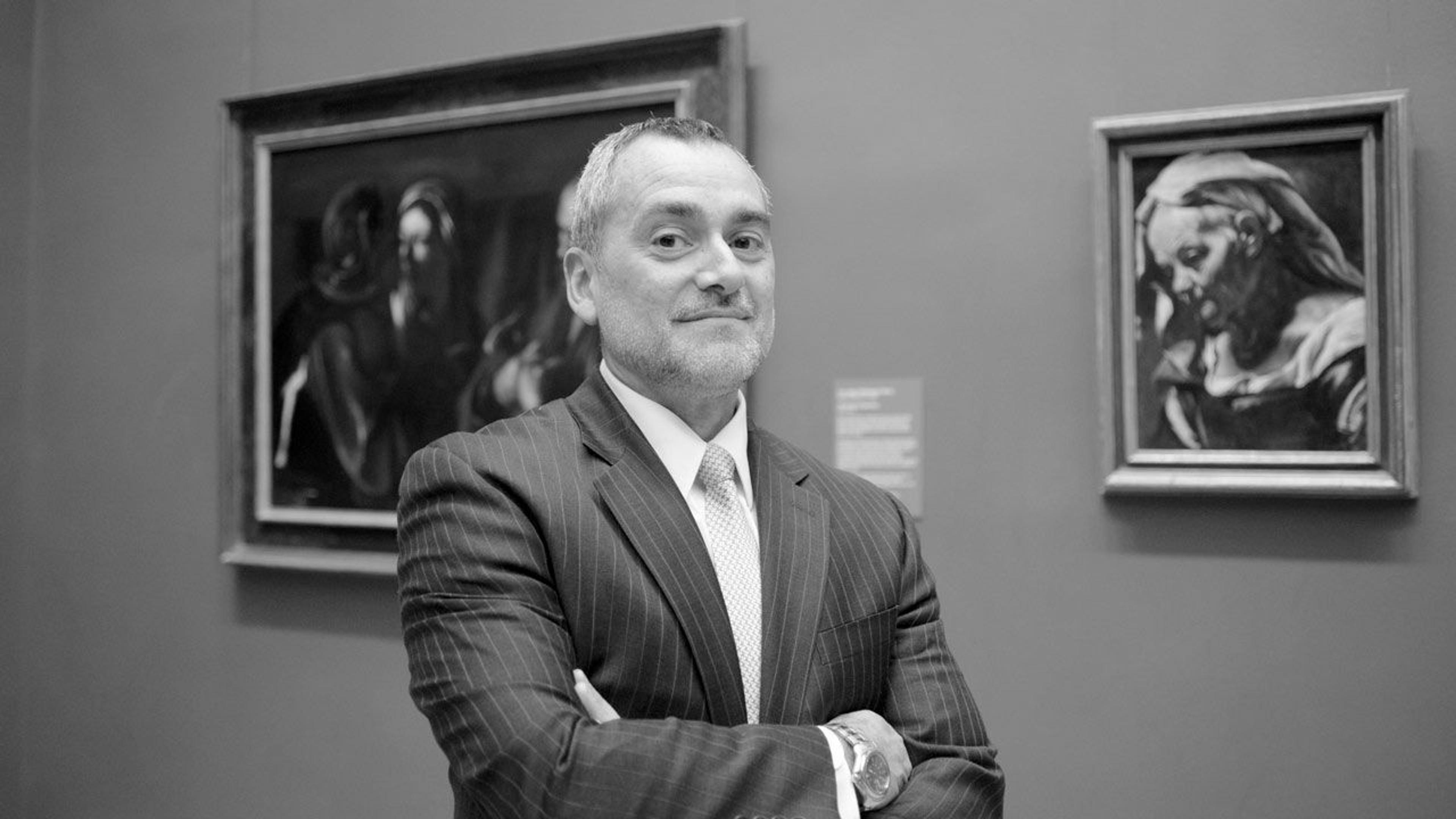 Black and white photograph of security manager Jose Rivero standing in a paintings gallery at The Met