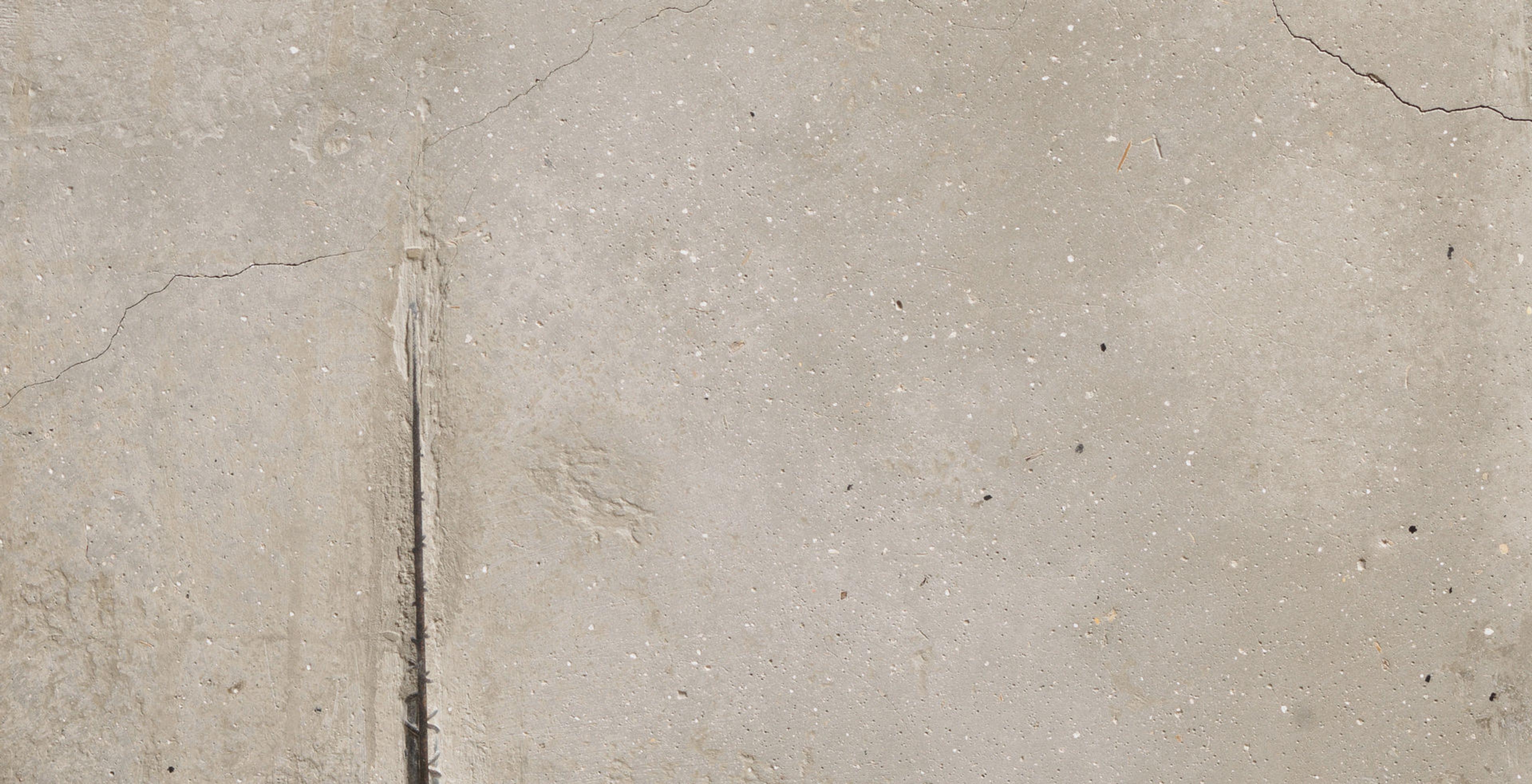 Detail of a concrete object with a crack running up the left side