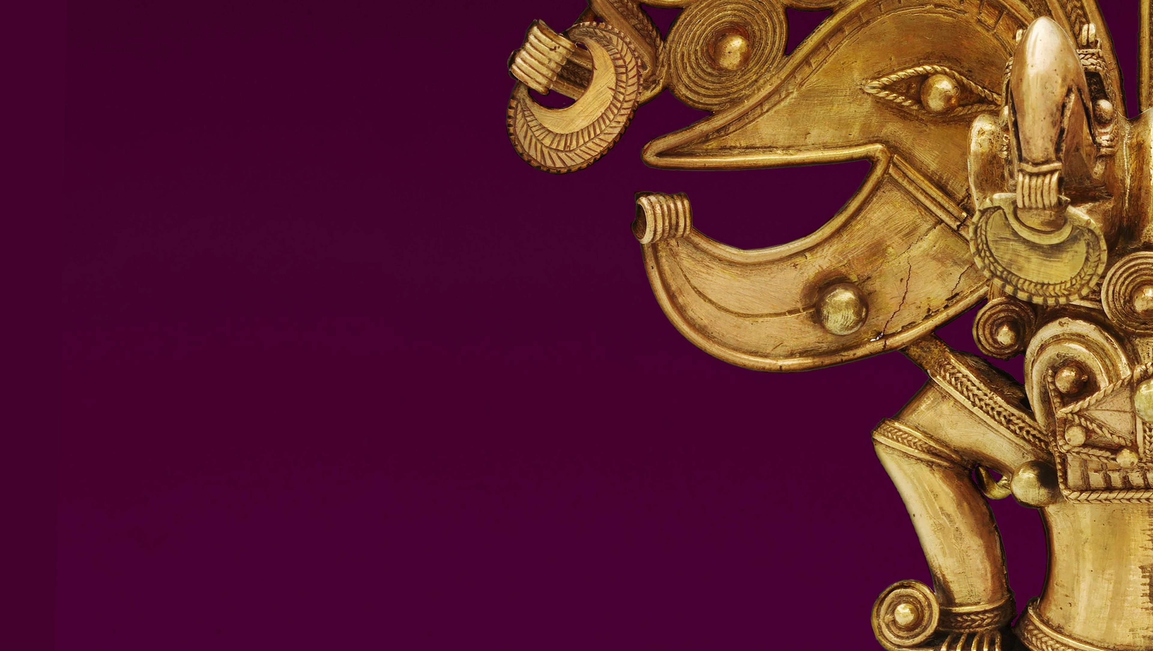 A cropped view of a figure in metal with decorative filigree