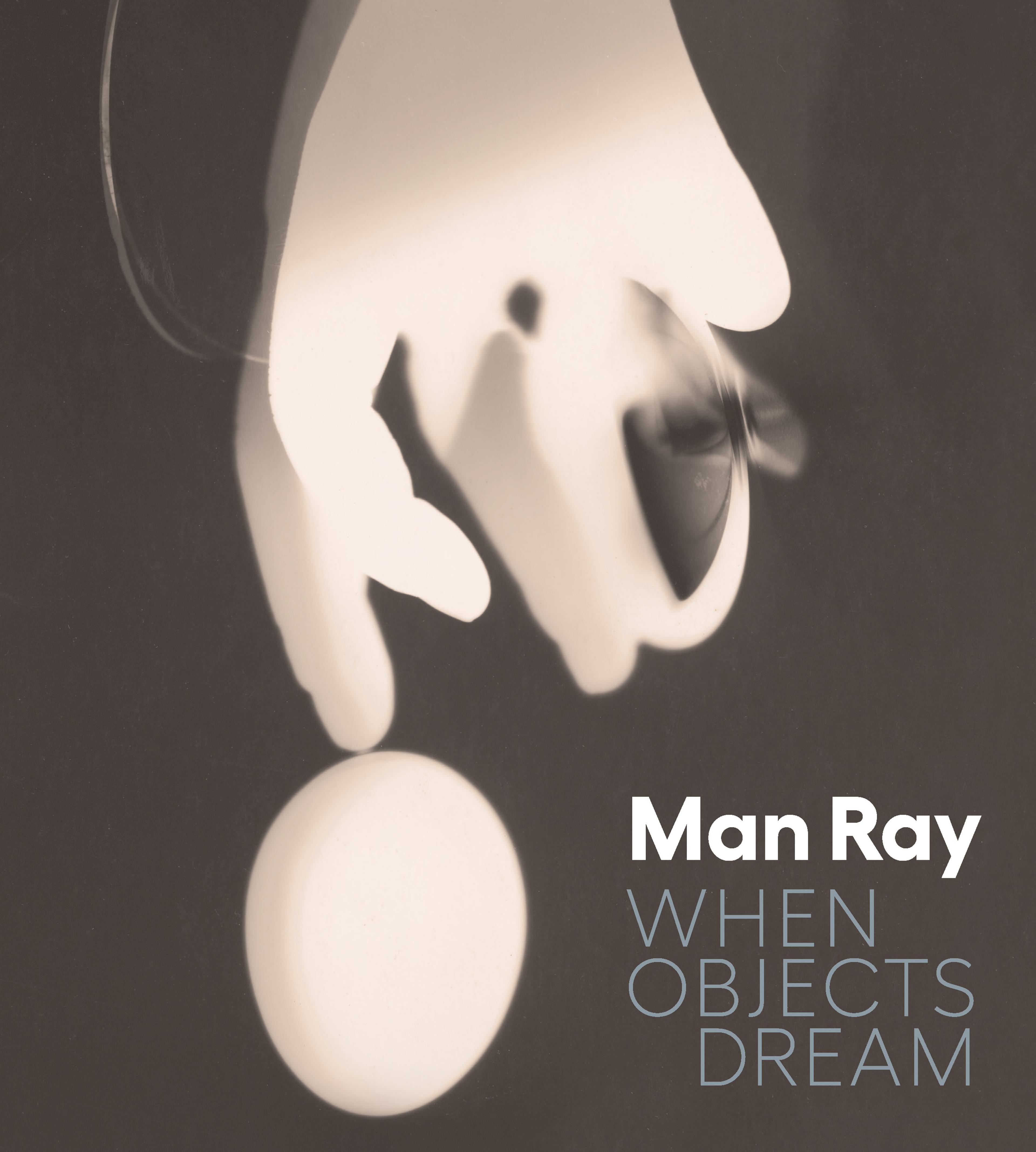 a hand, ghostly-white like an x-ray, reaching down to an egg with a blurred shape like a moth to the right