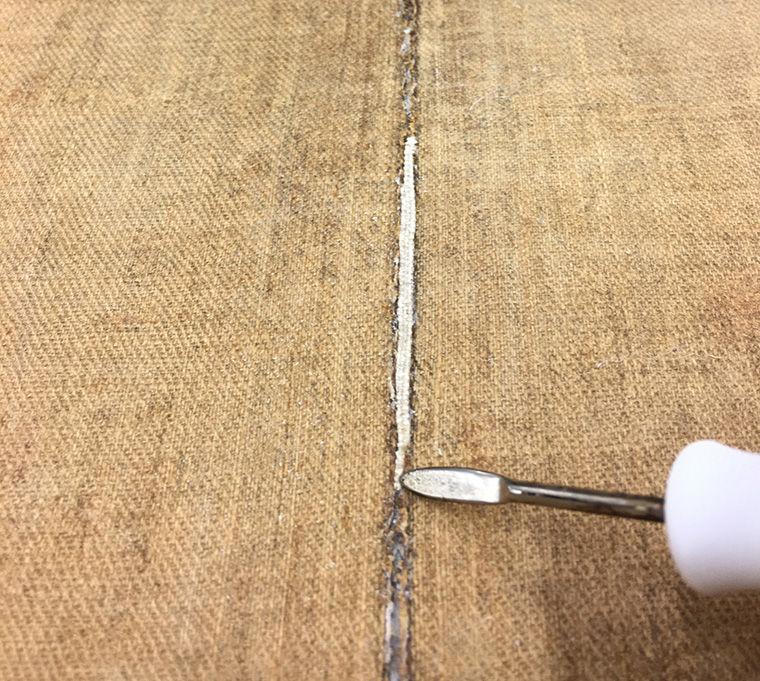 Conservation treatment of a painting, showing new areas of canvas being added to the back of the existing canvas