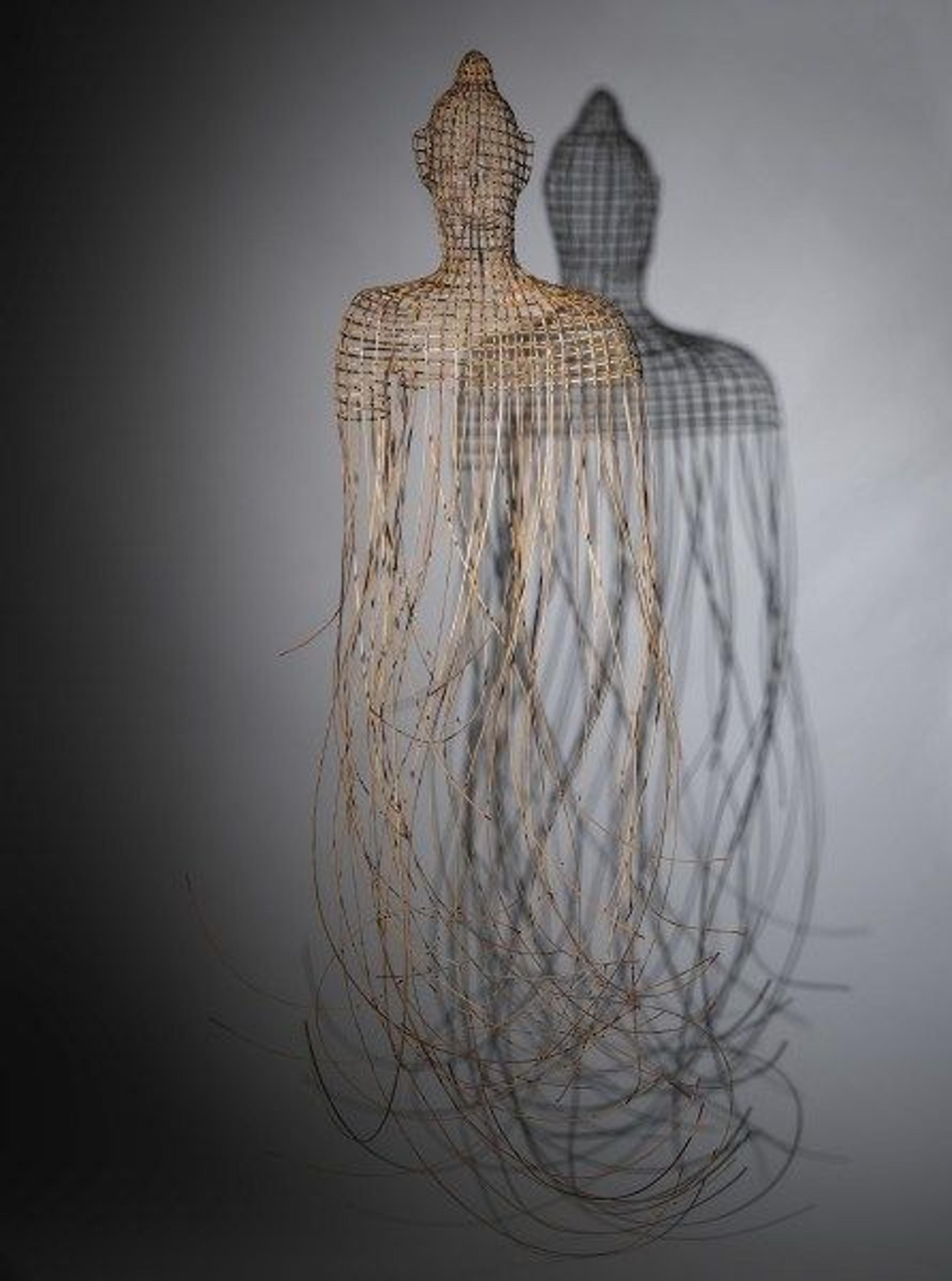 A hanging buddha woven out of ratan and wire by artist Sopheap Pich