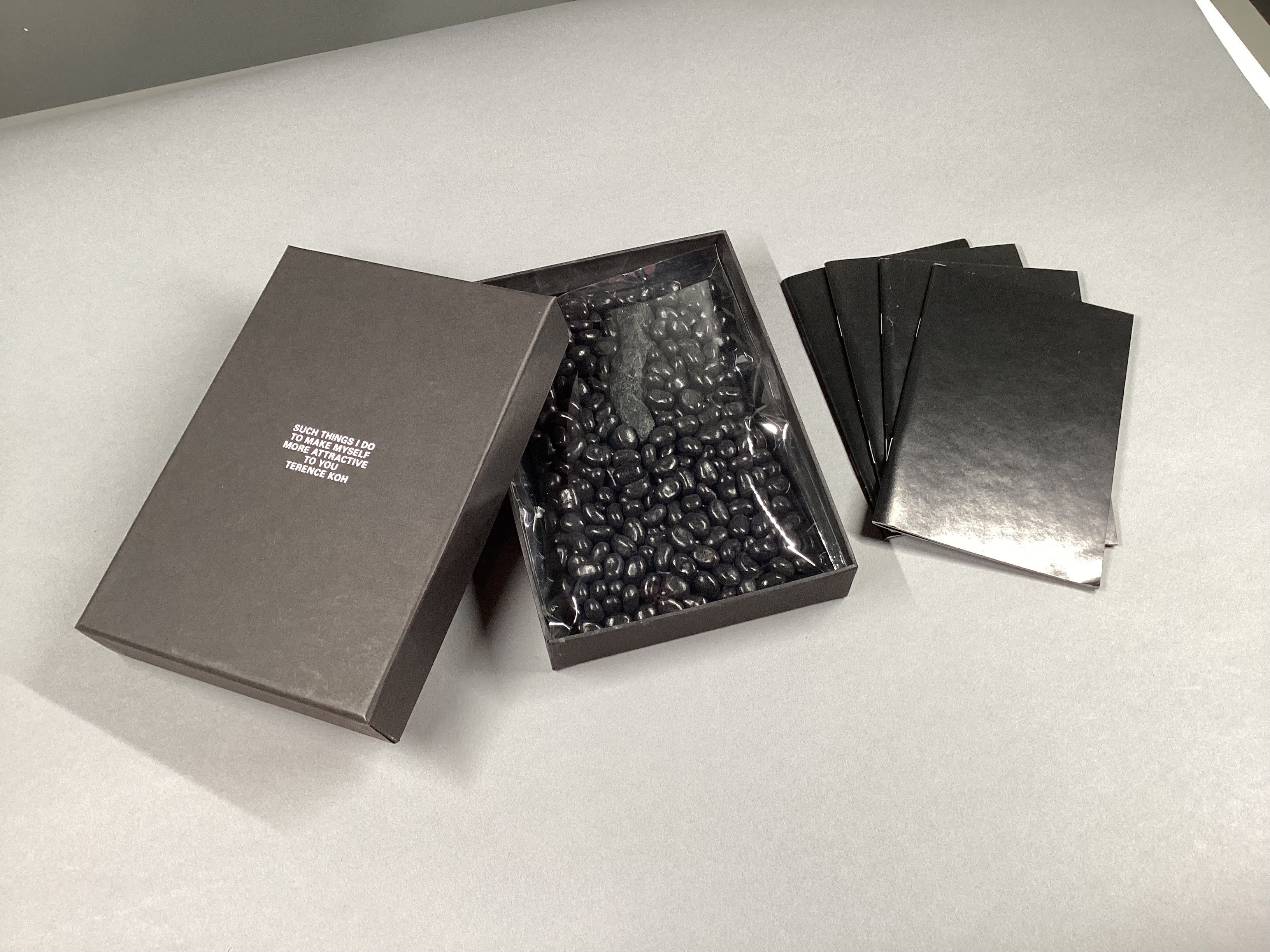 Black jelly beans in a box