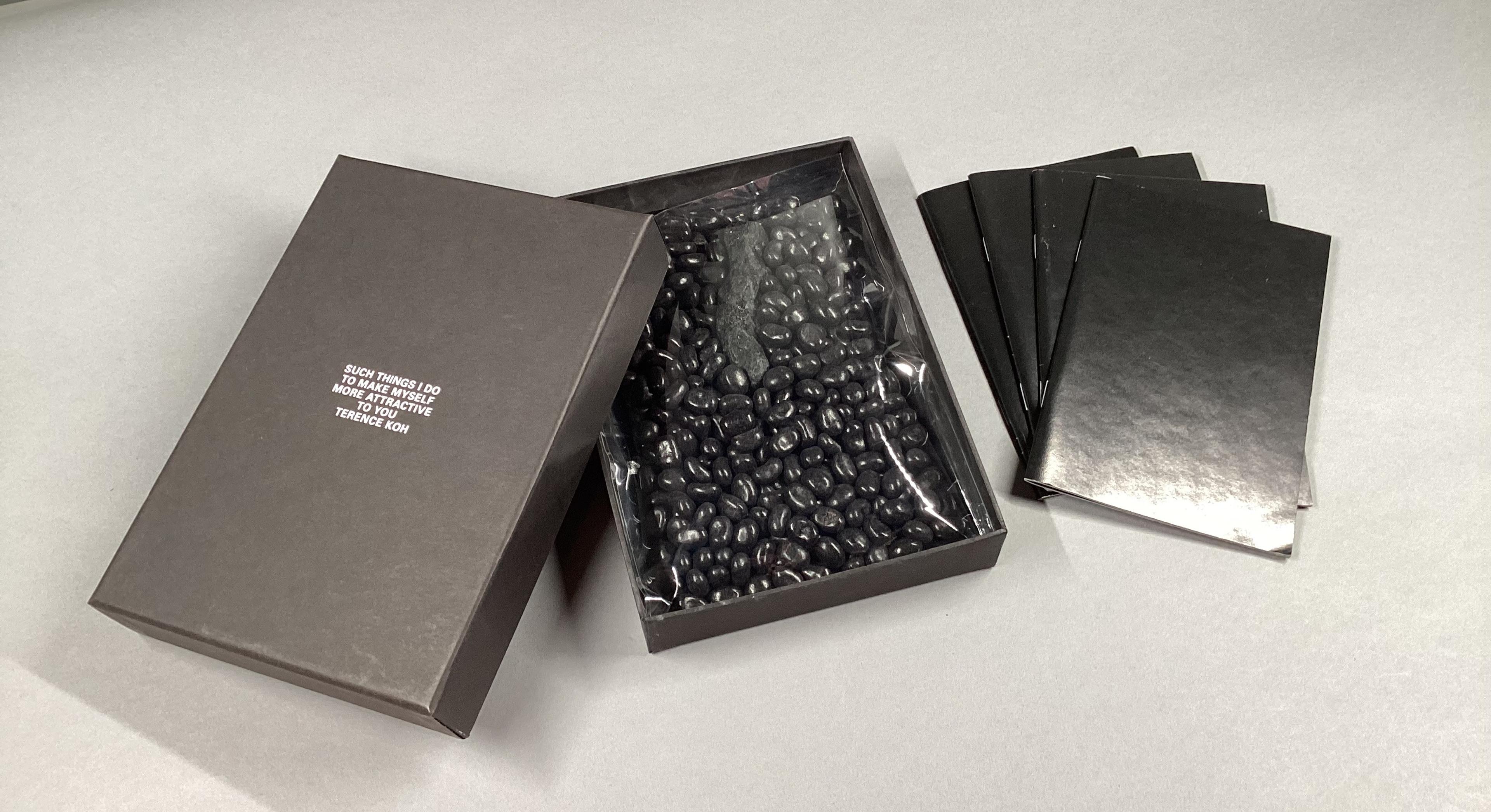 Black jelly beans in a box