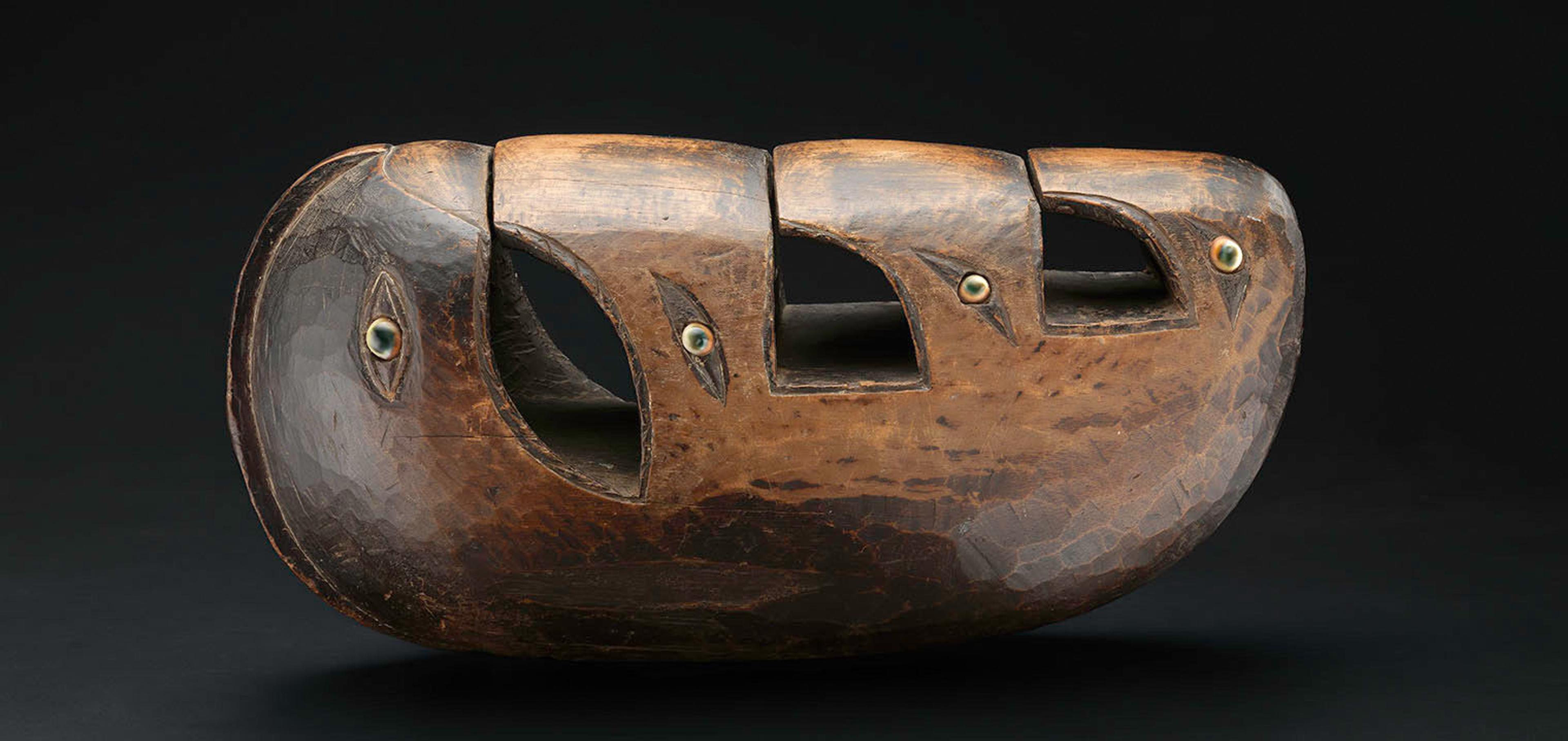A photograph of a wooden Friction Drum (Lunet or Livika) from Papa New Guinea.
