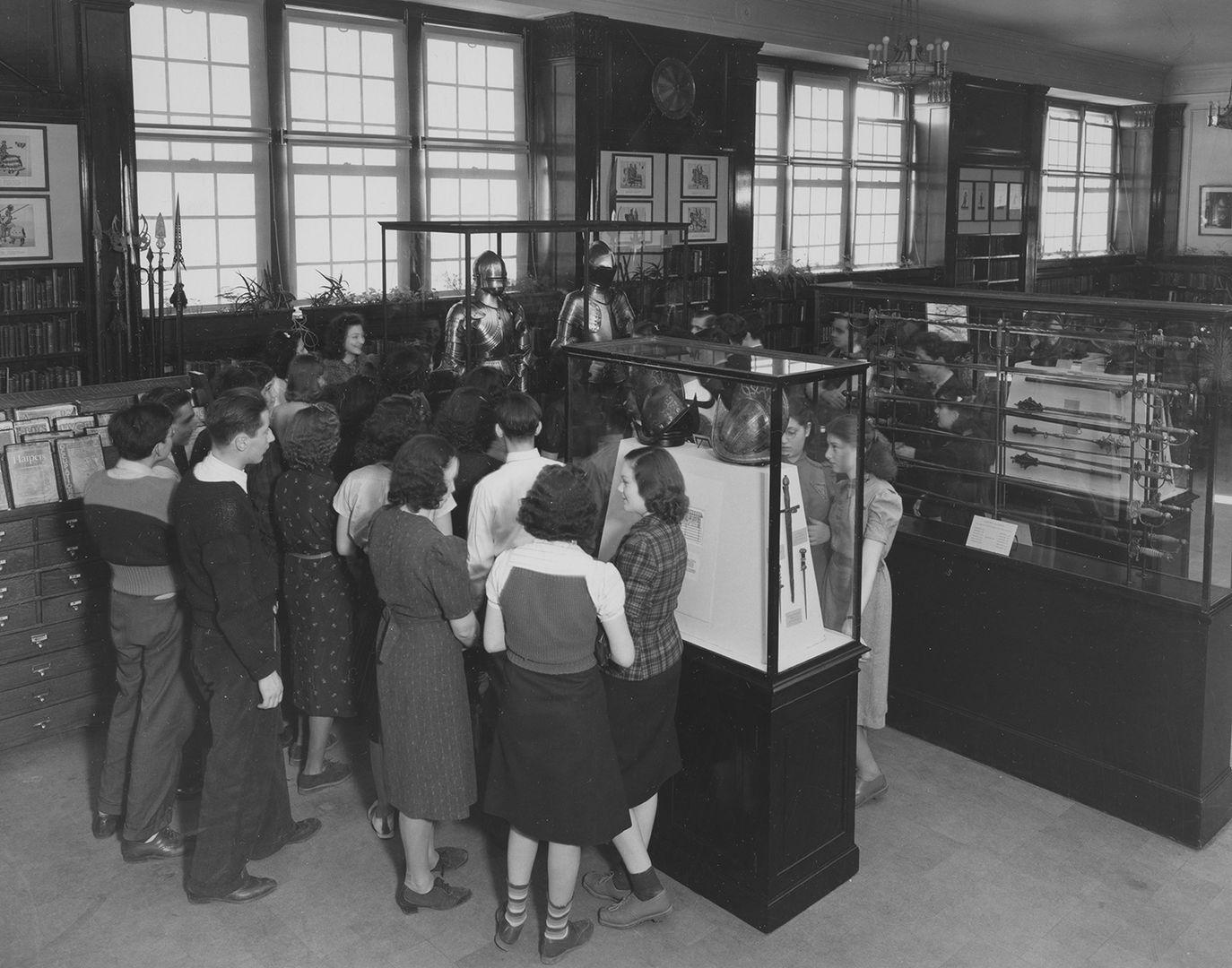 Group of students from The Bronx looking at Arms and Armor at The Met in the 1930s.