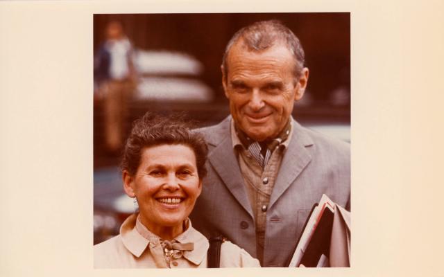 Sepia-toned photograph of a smiling Ray and Charles Eames
