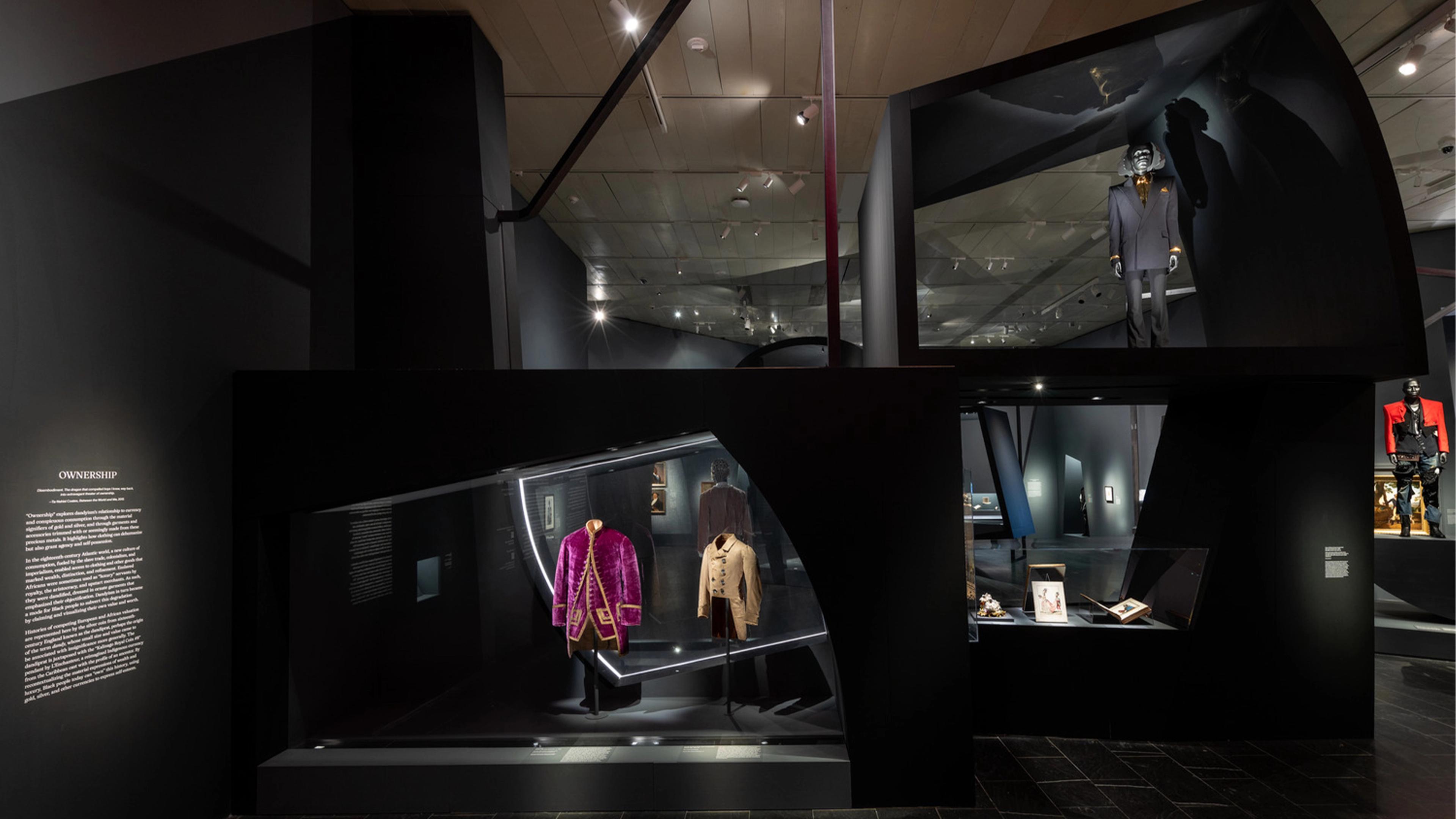 Gallery view of the exhibition. Suits displayed
