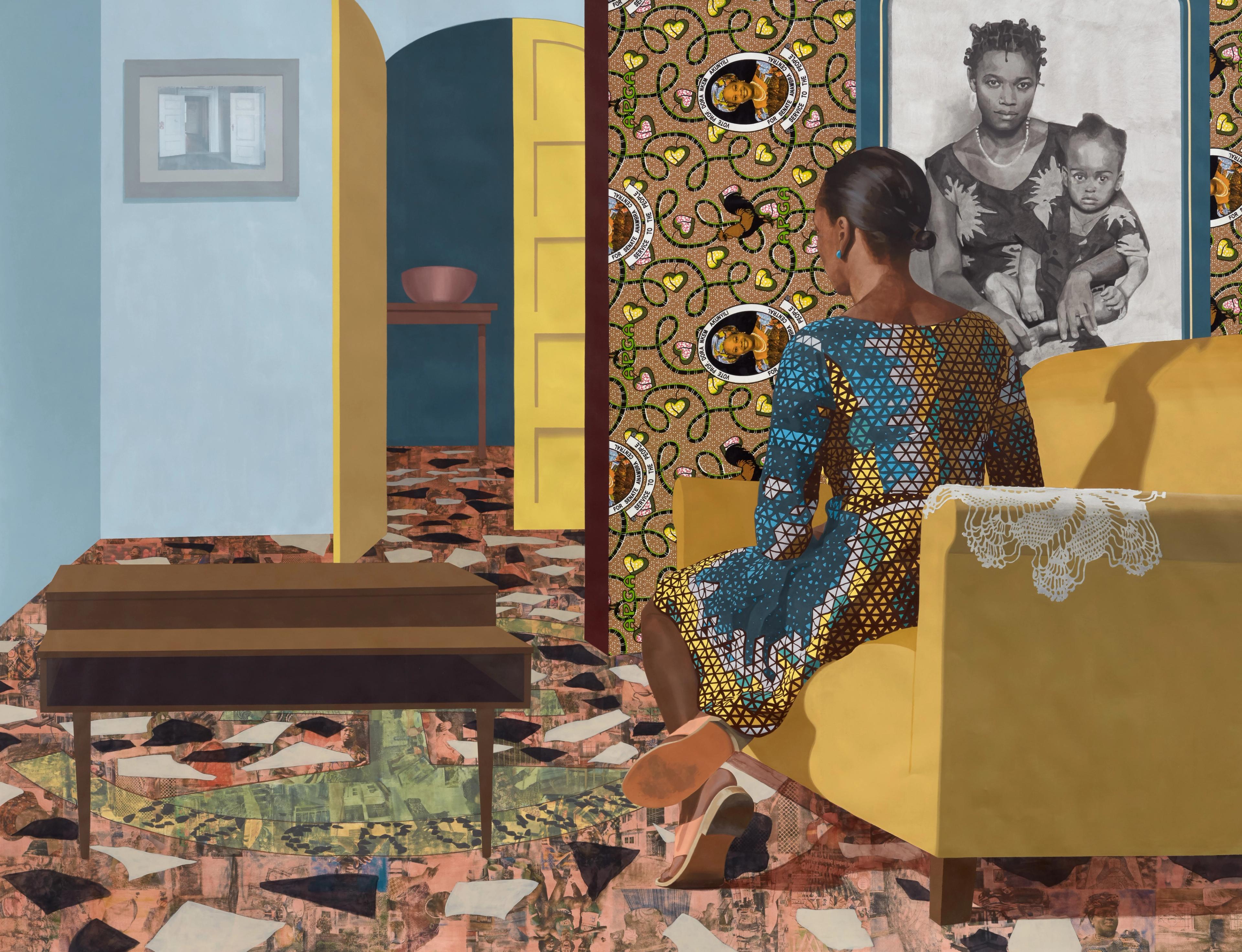 A woman in a patterned dress sits on a yellow couch, facing a sepia portrait of a mother and child. The room has vibrant wallpaper and a mosaic floor.