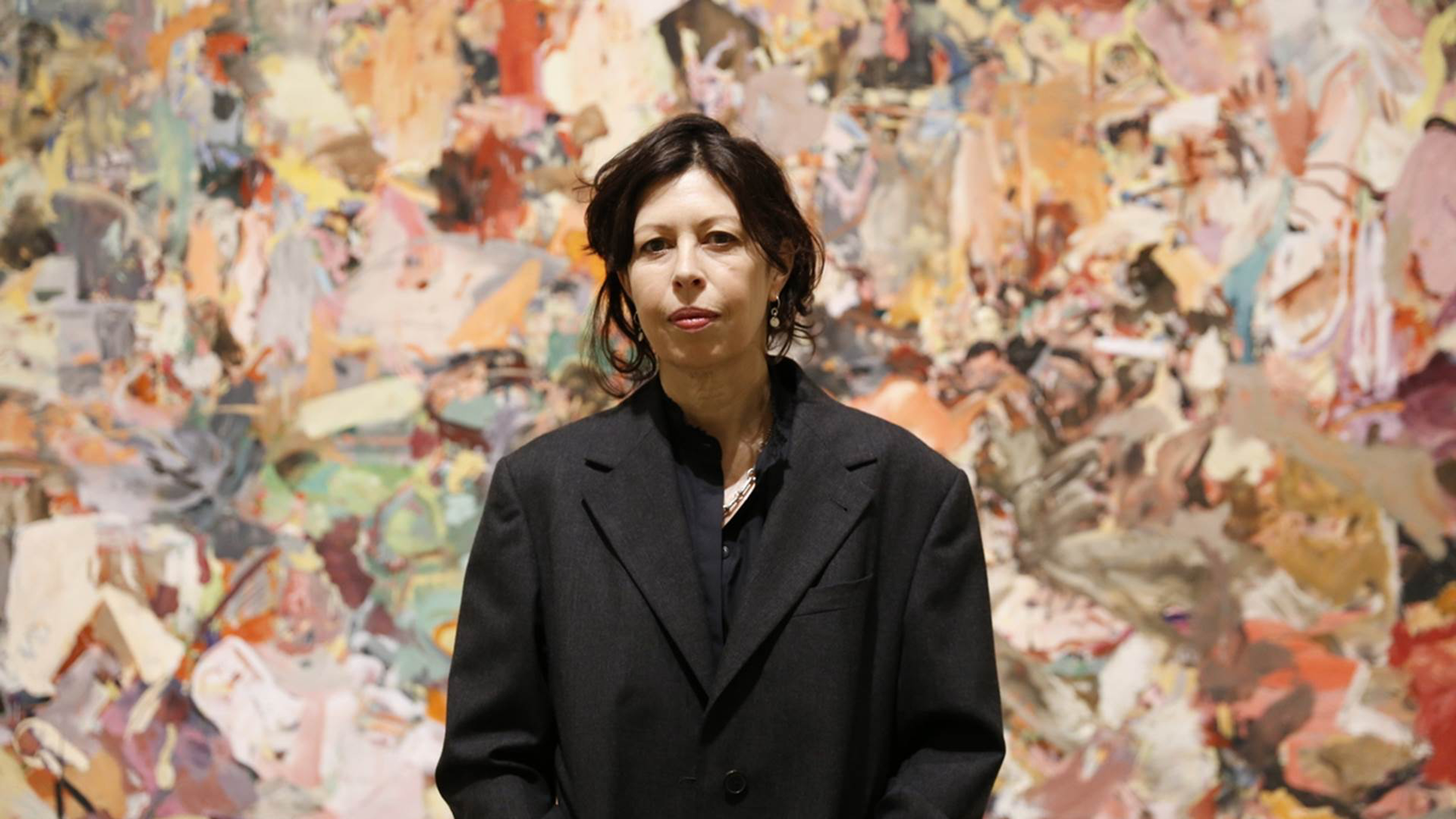 Image of the artist cecily brown in front of an abstraction.