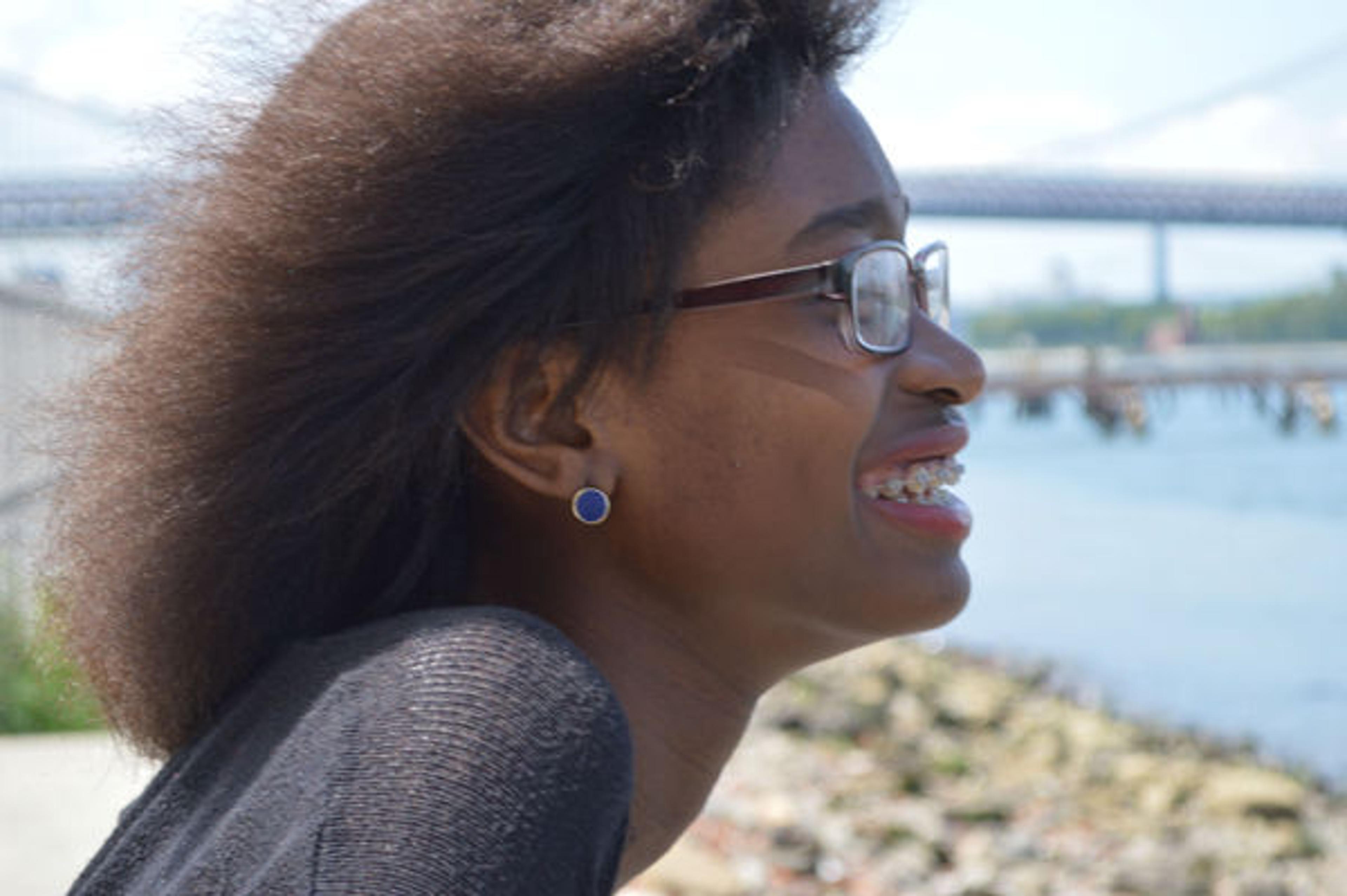 Young woman sitting near body of water
