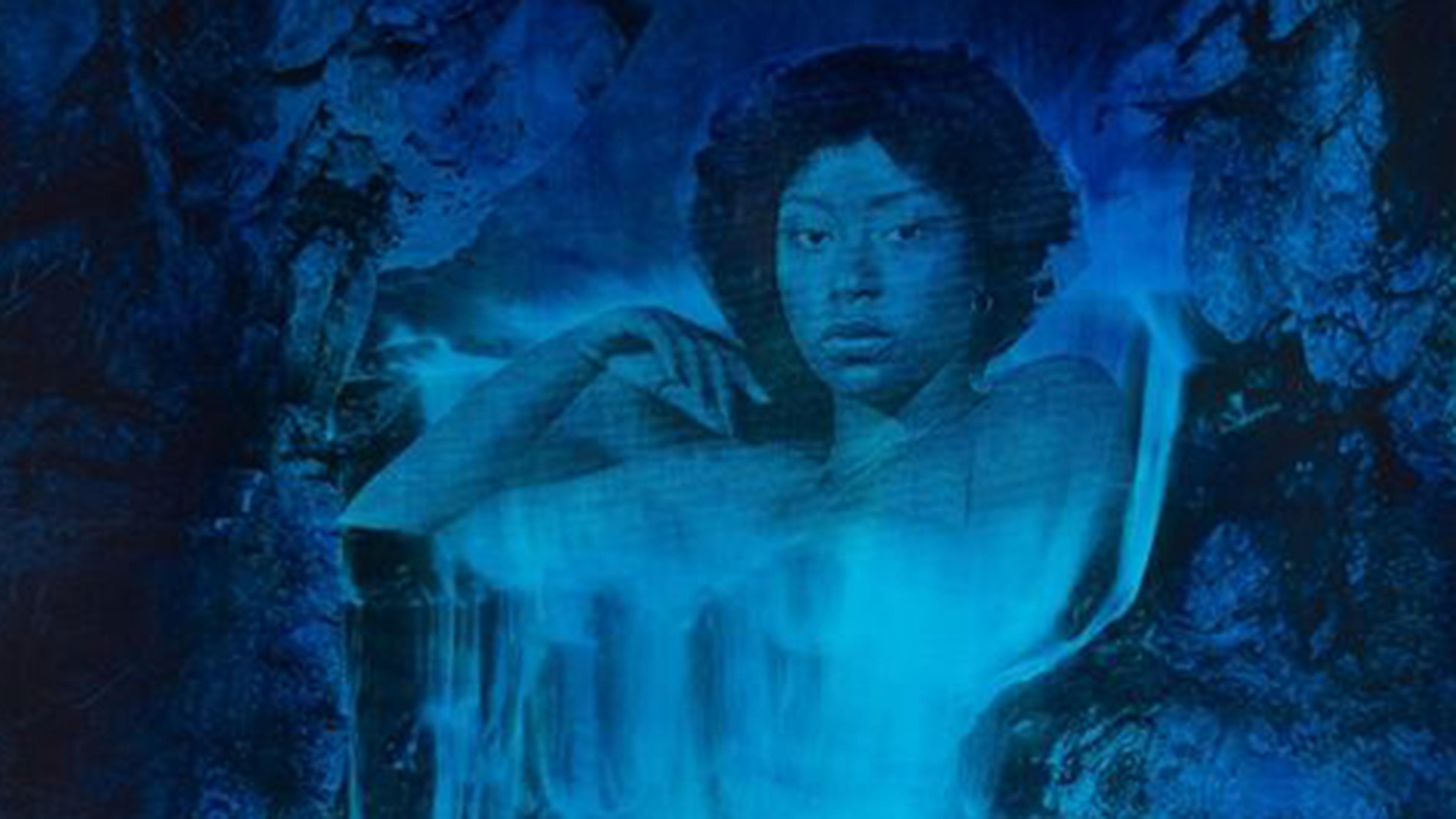 A woman emerging from rocks with her body transfproming into a waterfall