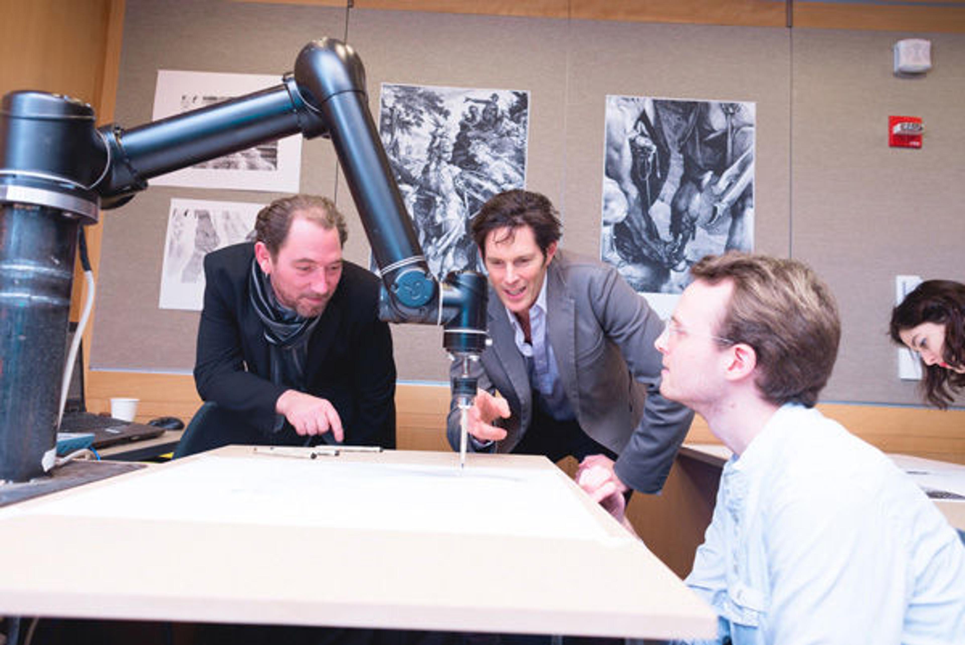 Mark Parsons (center), Cole Belmont, and Mark Kremer from The Consortium for Research and Robotics watching the UR-5 Robot arm draw