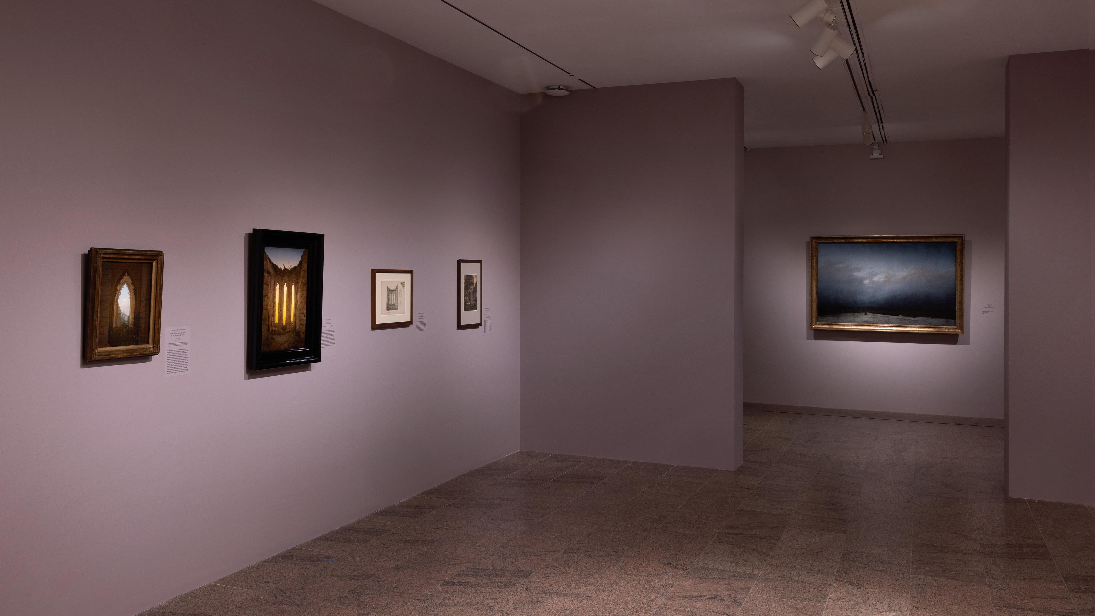 Wall gallery view with paintings hanging on the walls.
