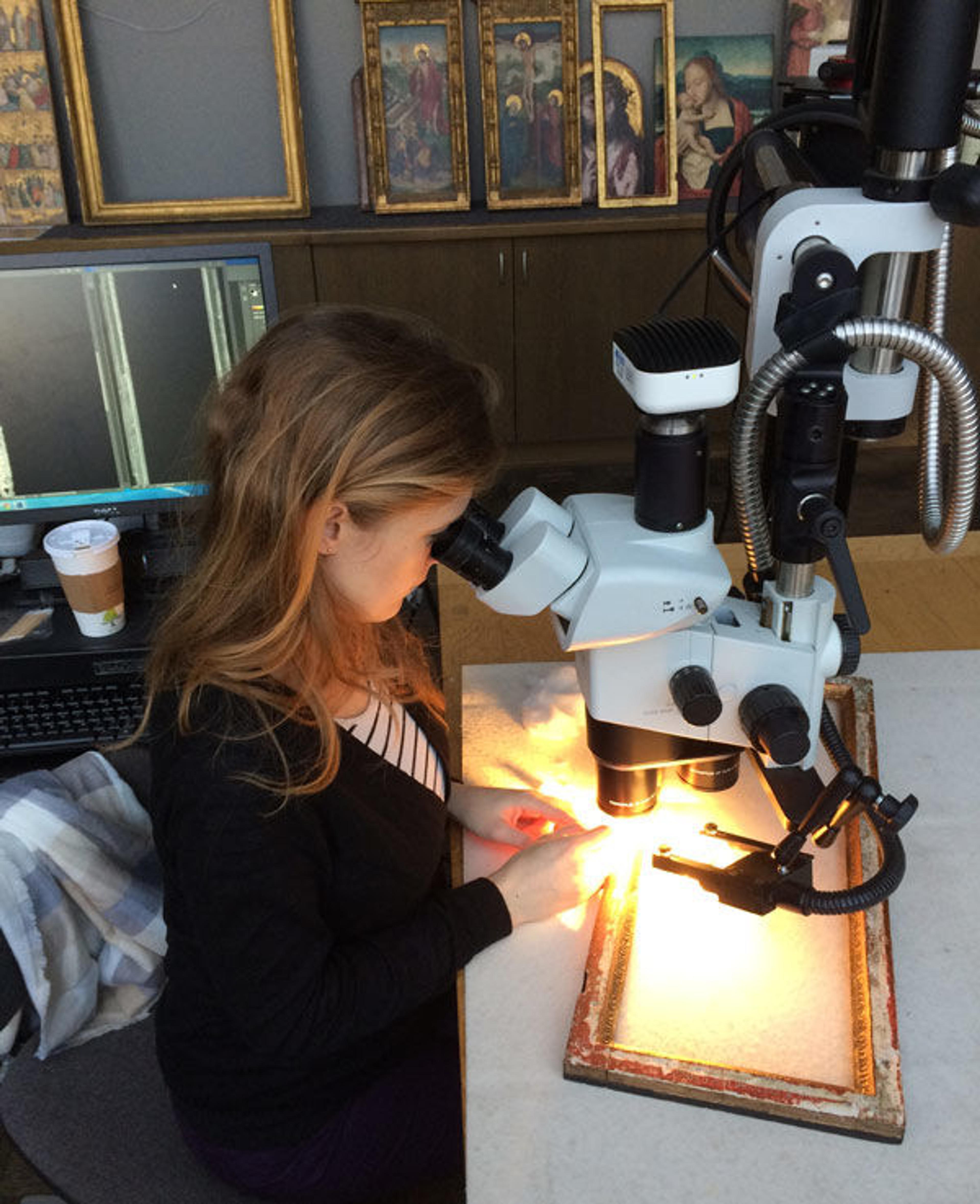Sophie Scully looks through a microscope