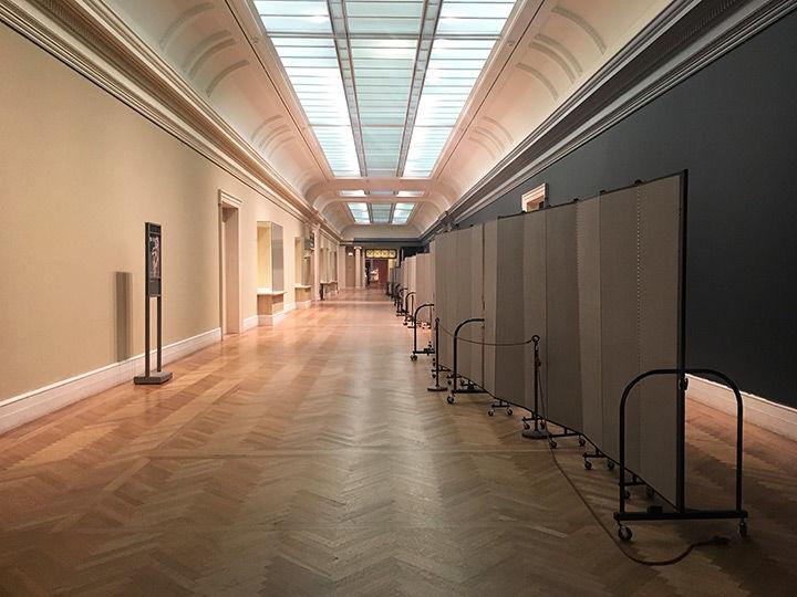 Gallery 800 serves as a long artery connecting some of The Met's most highly trafficked second-floor spaces. It was impossible, therefore, to close the space entirely for renovations. Instead, visitors passing through the de-installed gallery caught a glimpse of the before-and-after wall colors: speckled yellow-beige on their left and slate-gray on their right.