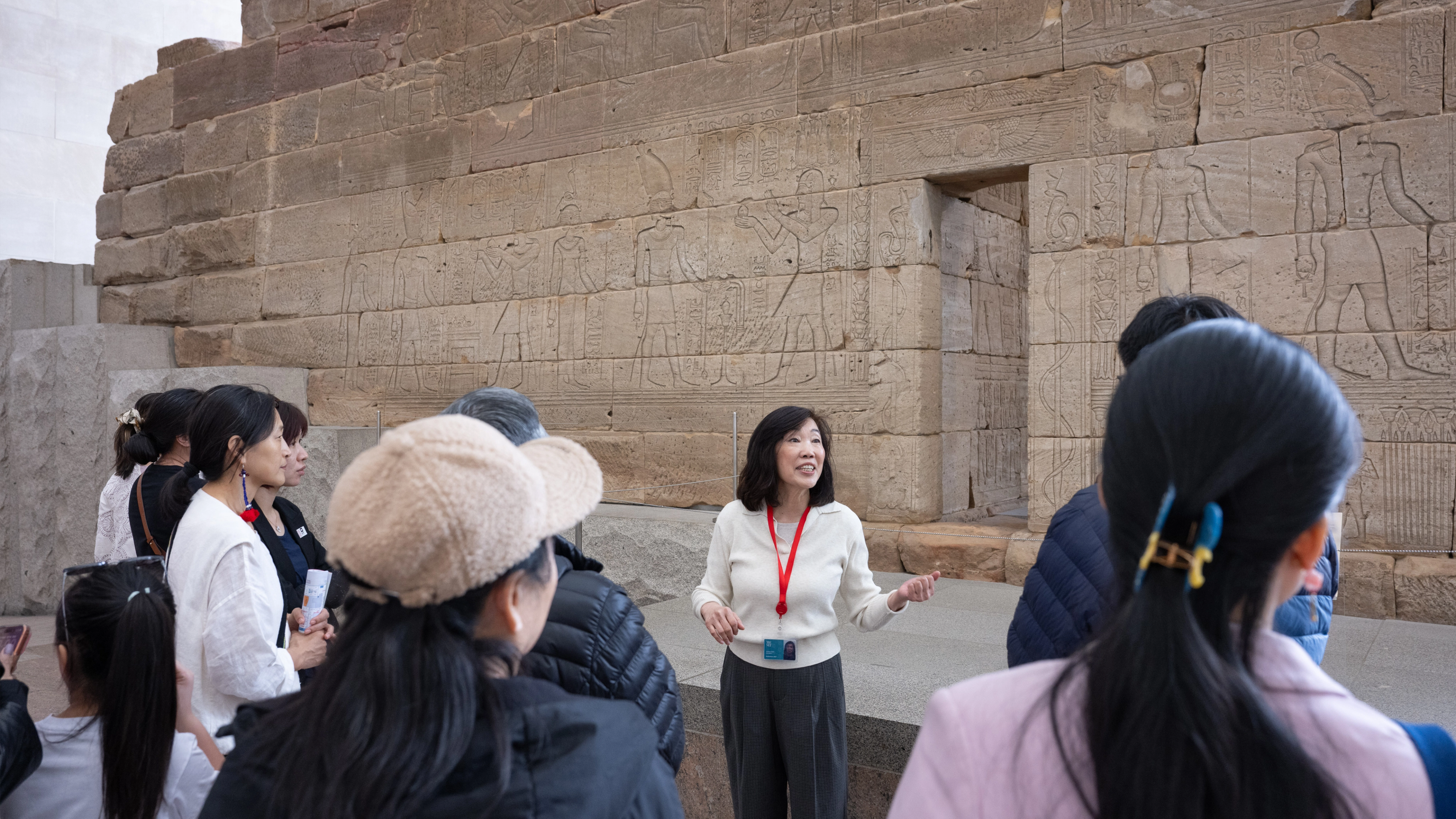 A tour guide in front of the Temple of Dendur. 